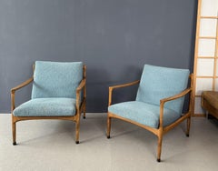 A pair of turquoise armchairs