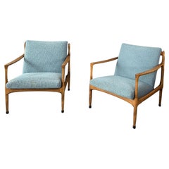 A pair of turquoise armchairs
