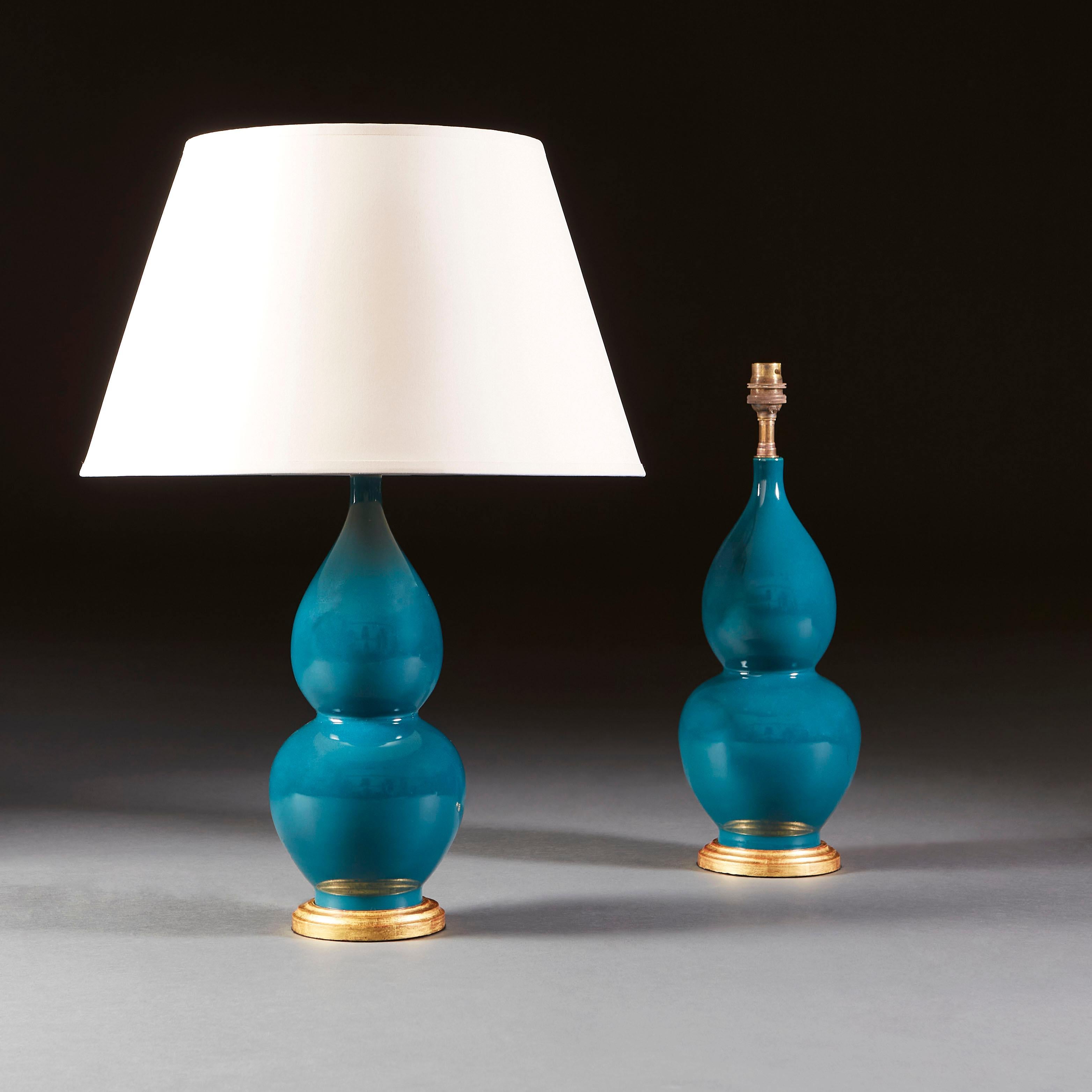 A fine pair of early twentieth century turquoise Chinese vases of double gourd form, now converted as lamps with turned giltwood bases.

Currently wired for the UK.

Please note: lampshades not included.