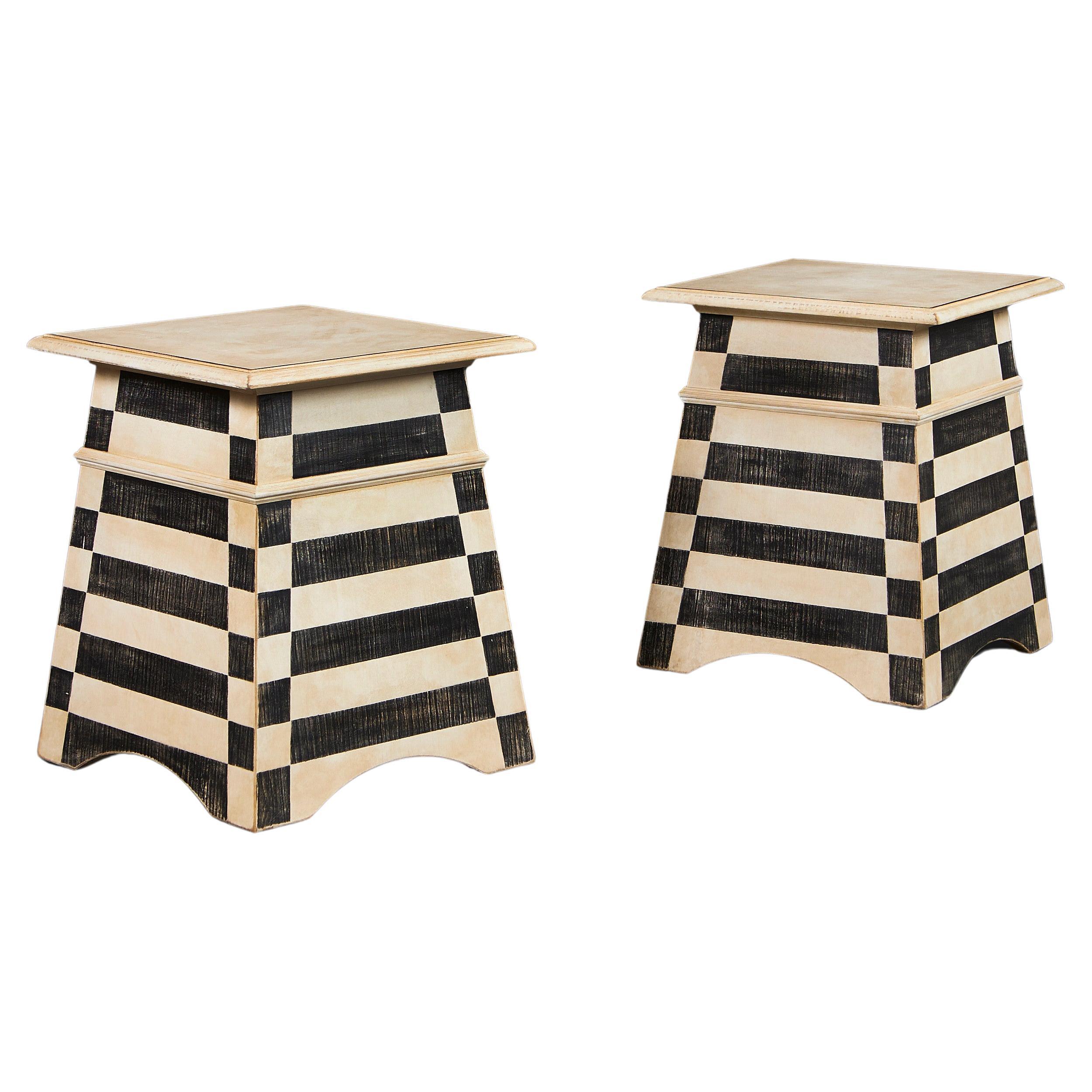 A pair of Tuscan style black and white painted side tables For Sale