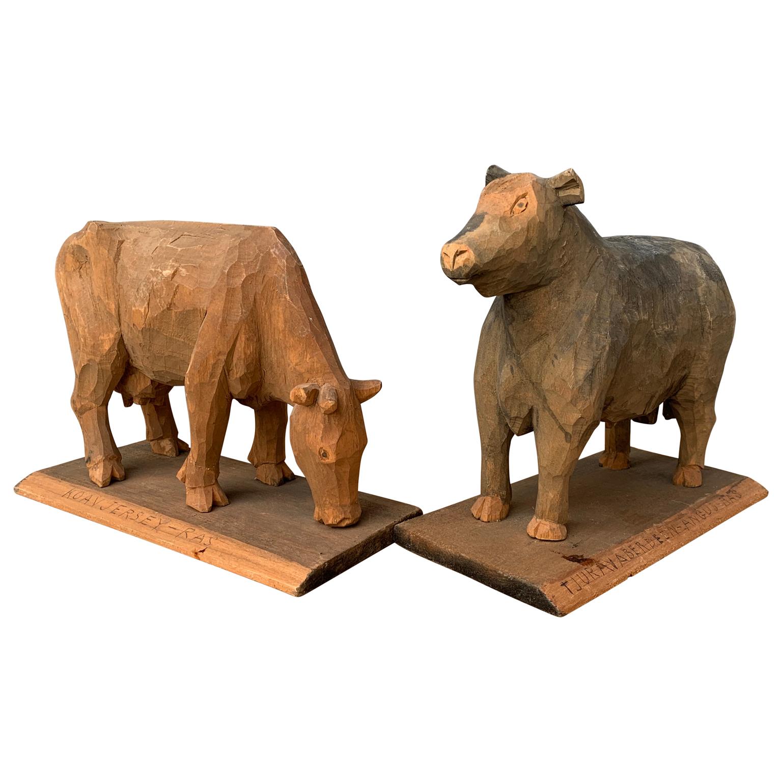A Swedish pair of wooden carved figures, the cow of the 
