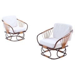 A pair of two-tone French rattan chairs with cushions. Circa 1970