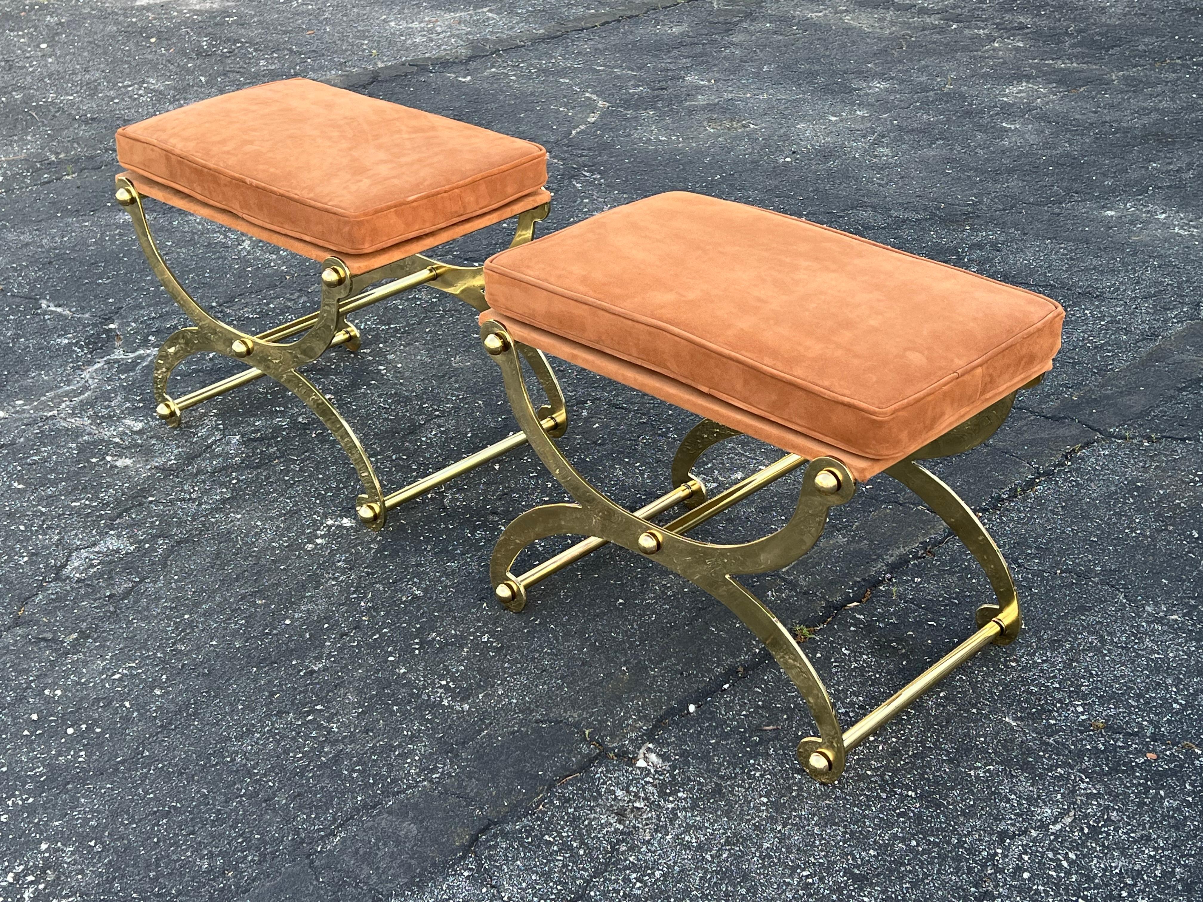 A pair of rare benches in solid brass by John Vesey, ca' 1960's. Priced per pair (2 pairs or four stools available). Heavy brass, reupholstered in natural suede.
