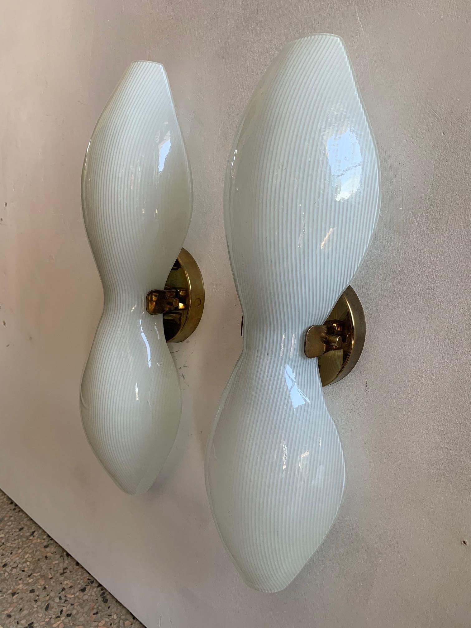 A pair of unusual sconces by Lightolier (signed), circa 1950s with hourglass, striped shades and brass holders.