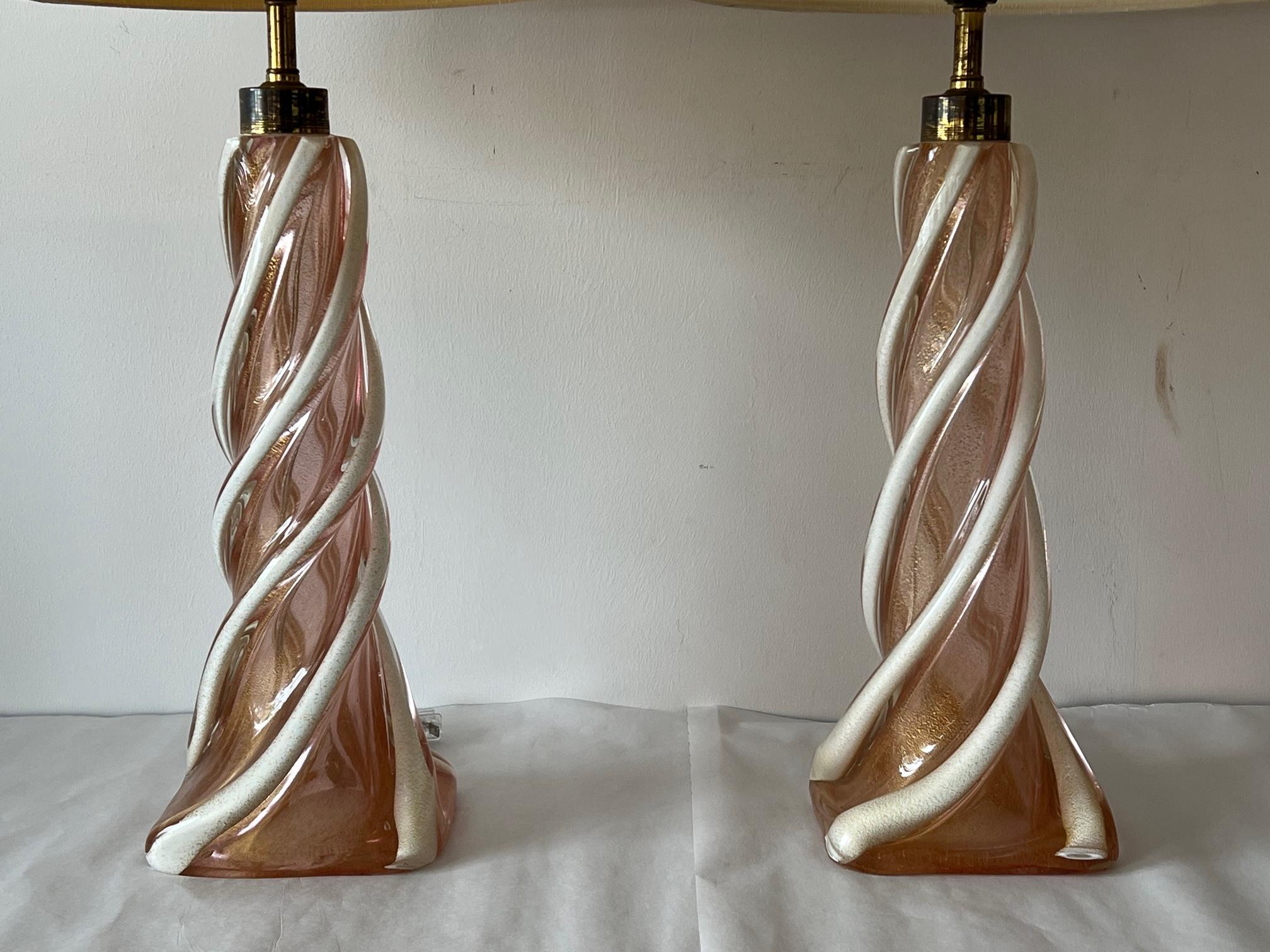 A pair of outstanding Murano lamps probably by Seguso. Heavy, with twisted cased glass decoration and gold flecks inside. 