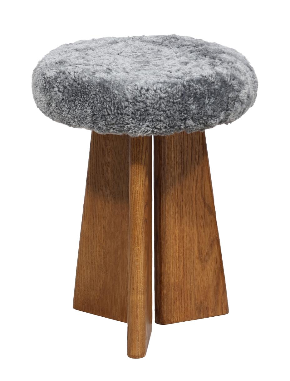 A pair of lambskin upholstered oak stools by Danish cabinetmaker Dansk Møbeldesign. Signed 