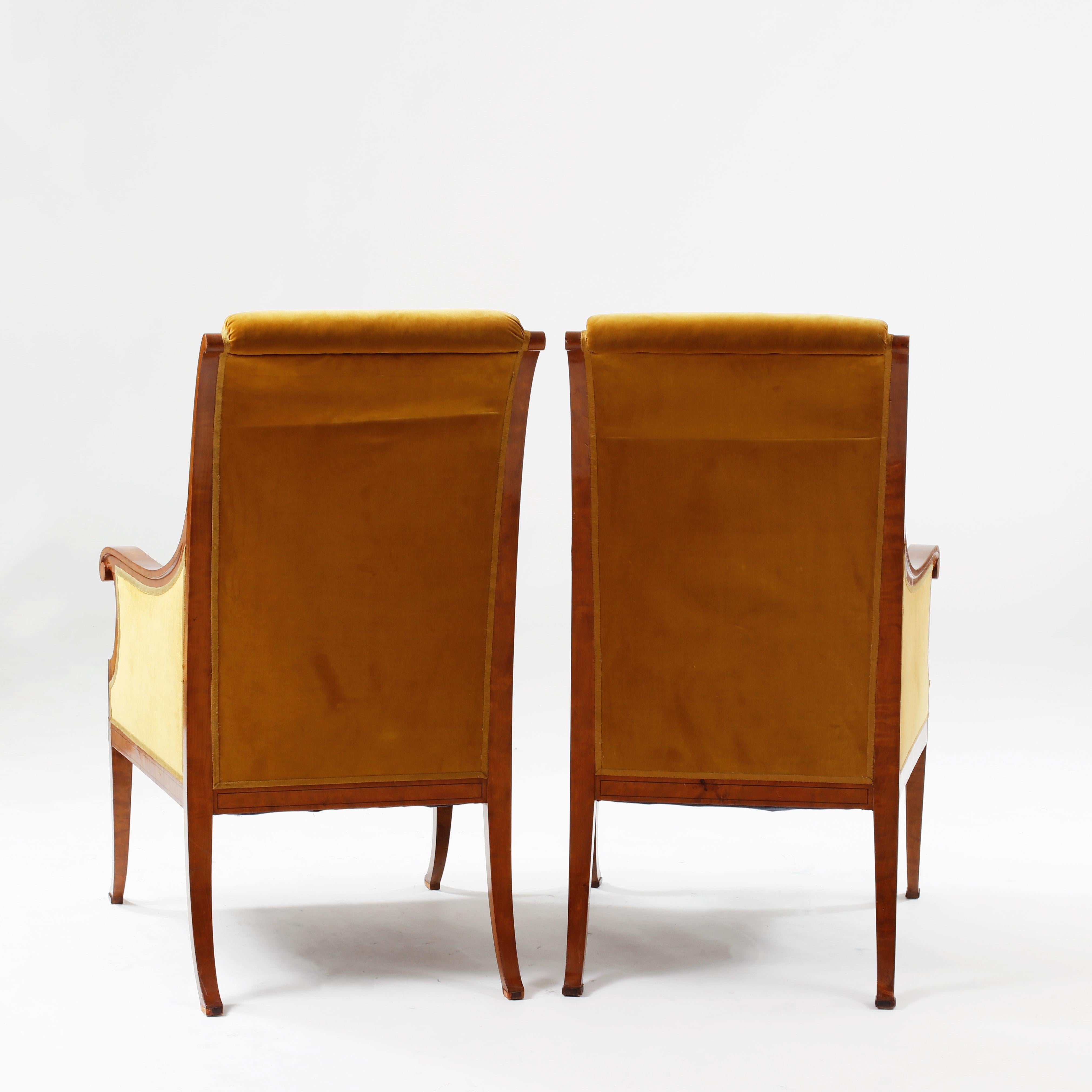 50% off original offer.   A pair of armchairs in golden velvet upholstery. Wood arms and legs with inlay pattern of stylized flowers. Generous proportions, built for tall Scandinavians!  Free delivery in NYC.    