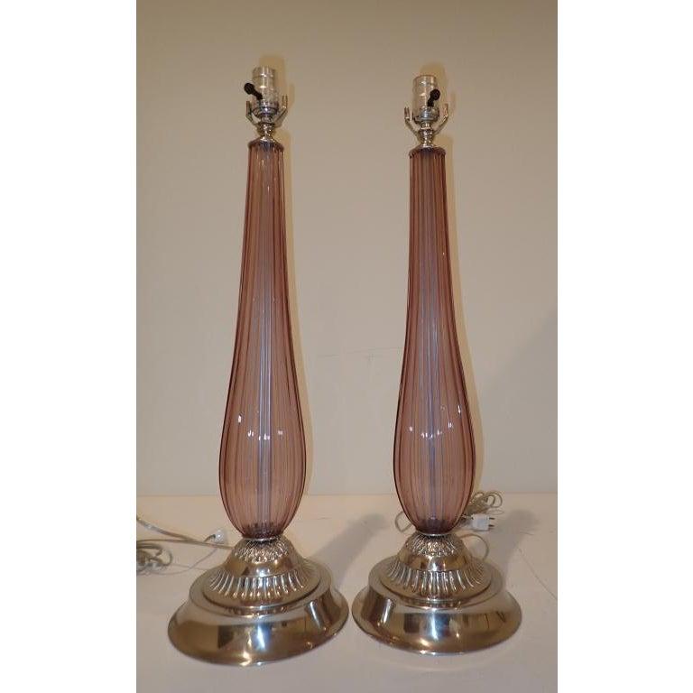 Pair of Italian Murano art glass table lamps. In the manner of Archimede Seguso. Beautiful Venetian ribbed translucent purple glass. Each fluted glass body sits on nickel over bronze base. Measures: 23
