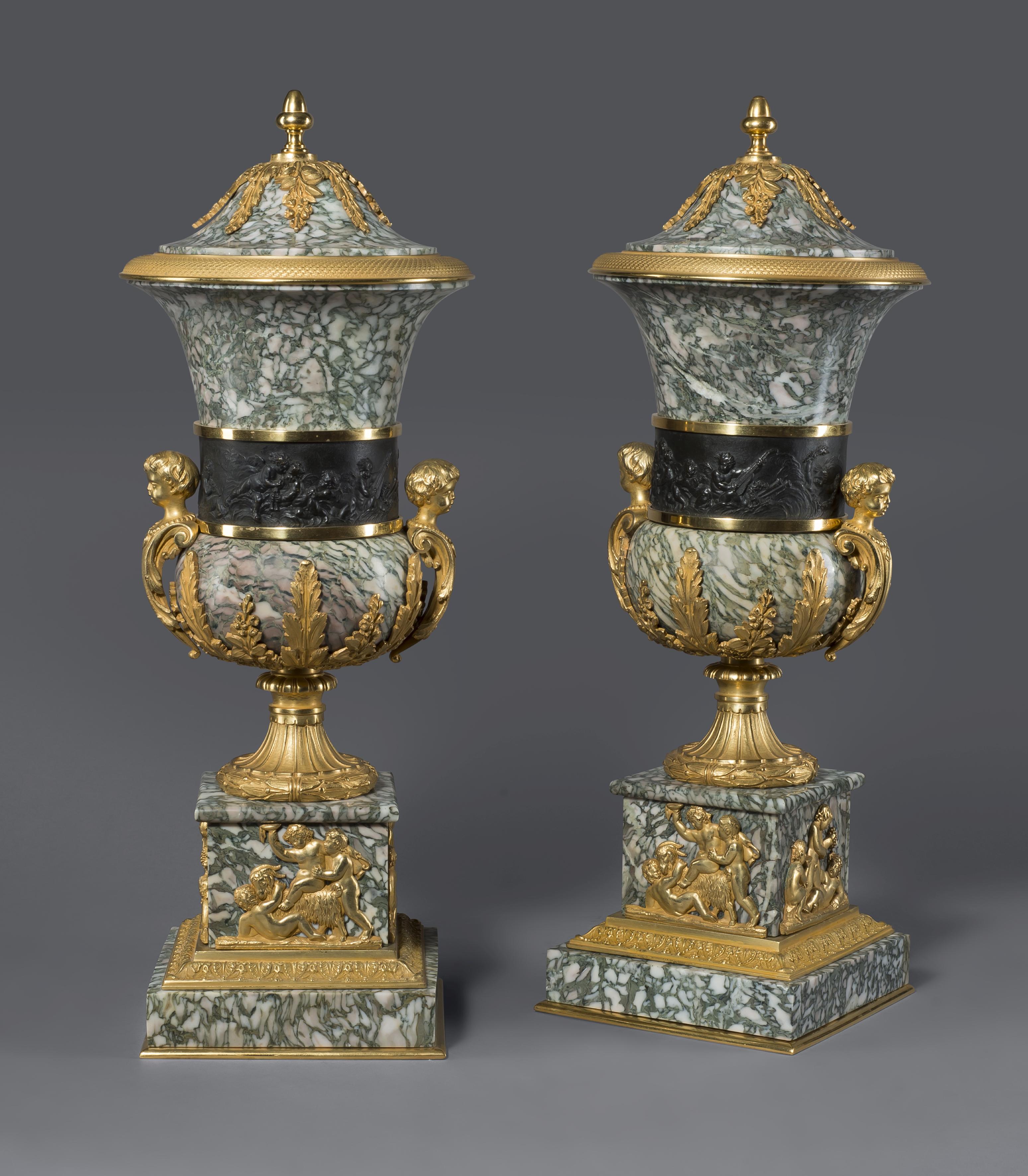 A pair of gilt and patinated bronze mounted verde chassagne marble vases and covers.

French, circa 1890.