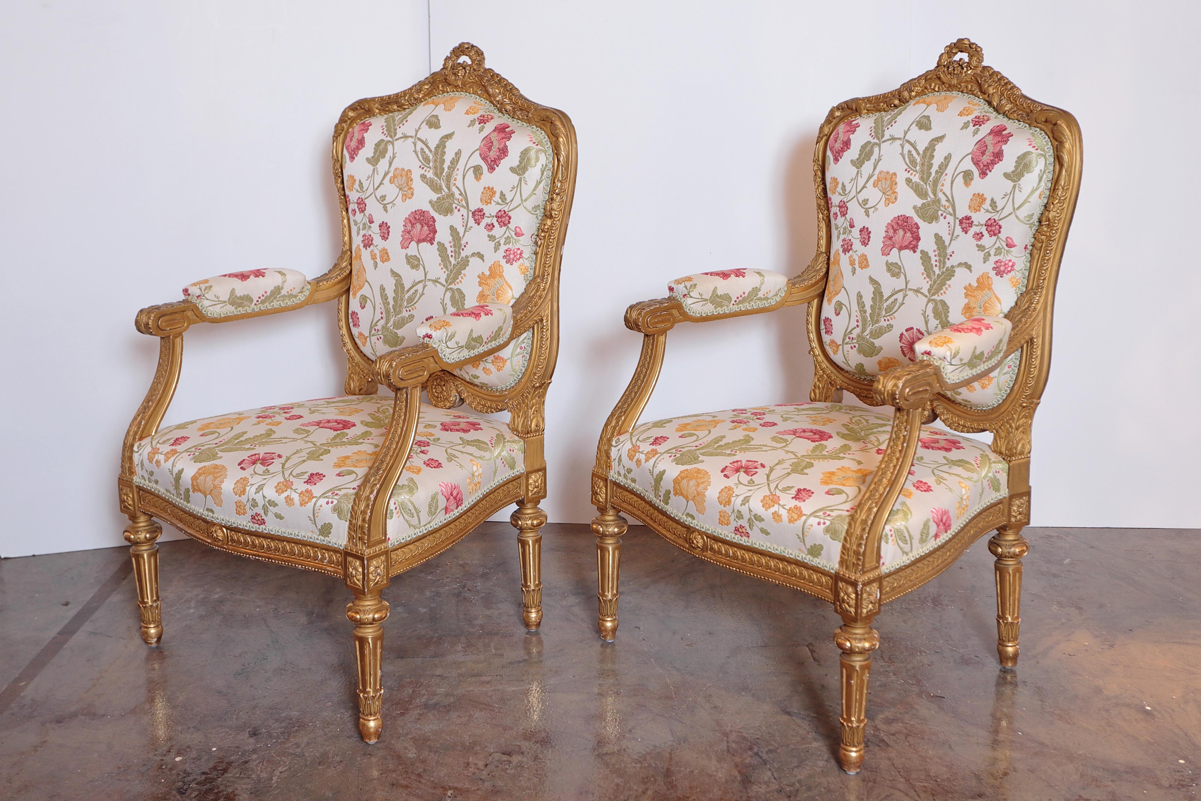 A pair of early 20th century French gilt carved fauteuils. Fine quality gilt carving. Covered in a Scalamandre fabric.