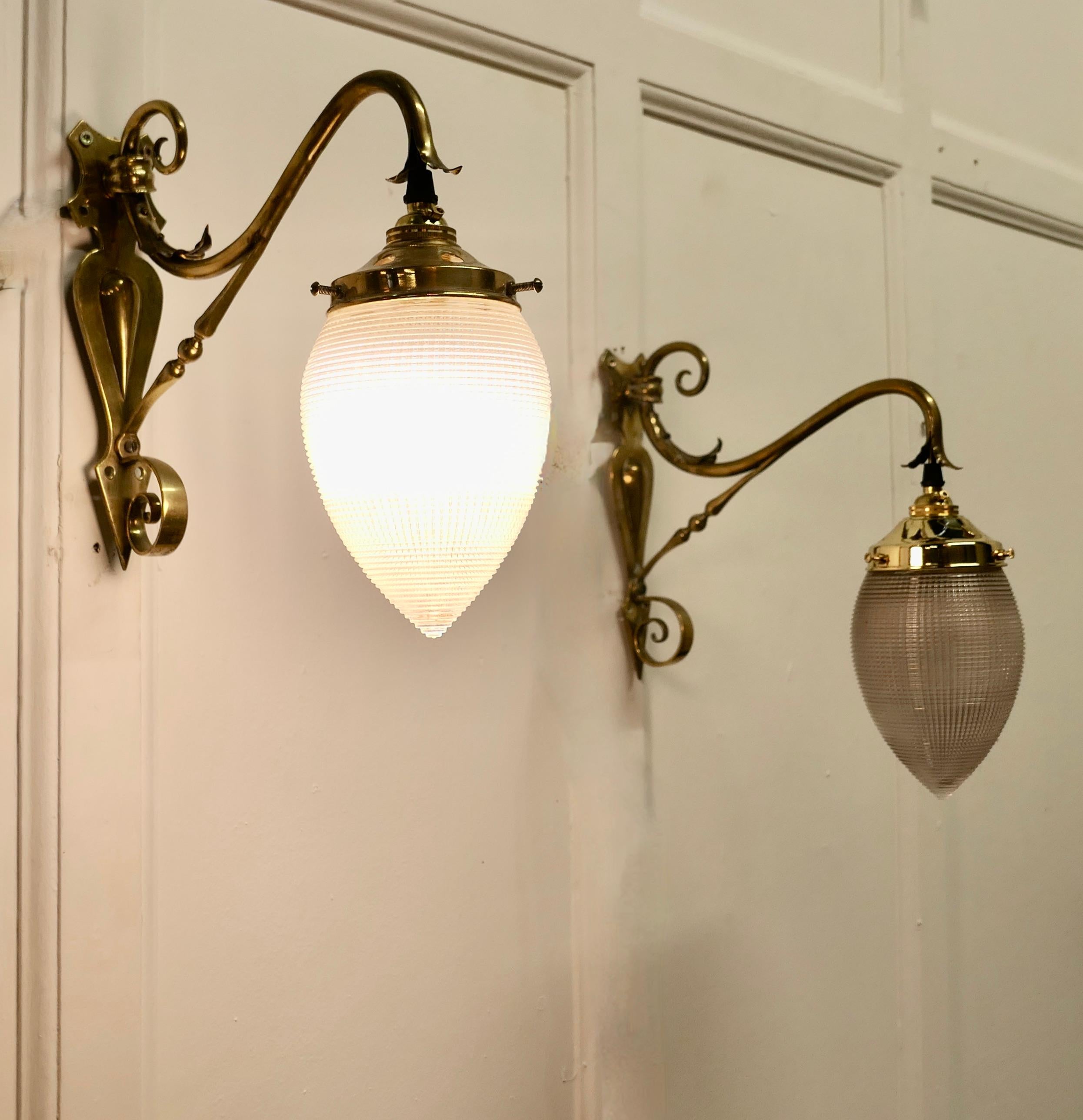 A pair of Victorian Arts and Crafts brass Swan neck wall lights, 

The Lights have decorative brass swan neck arms, they have original Glass Beehive Glass Shades 

All in working order, these lights will need to be connected to an electrical