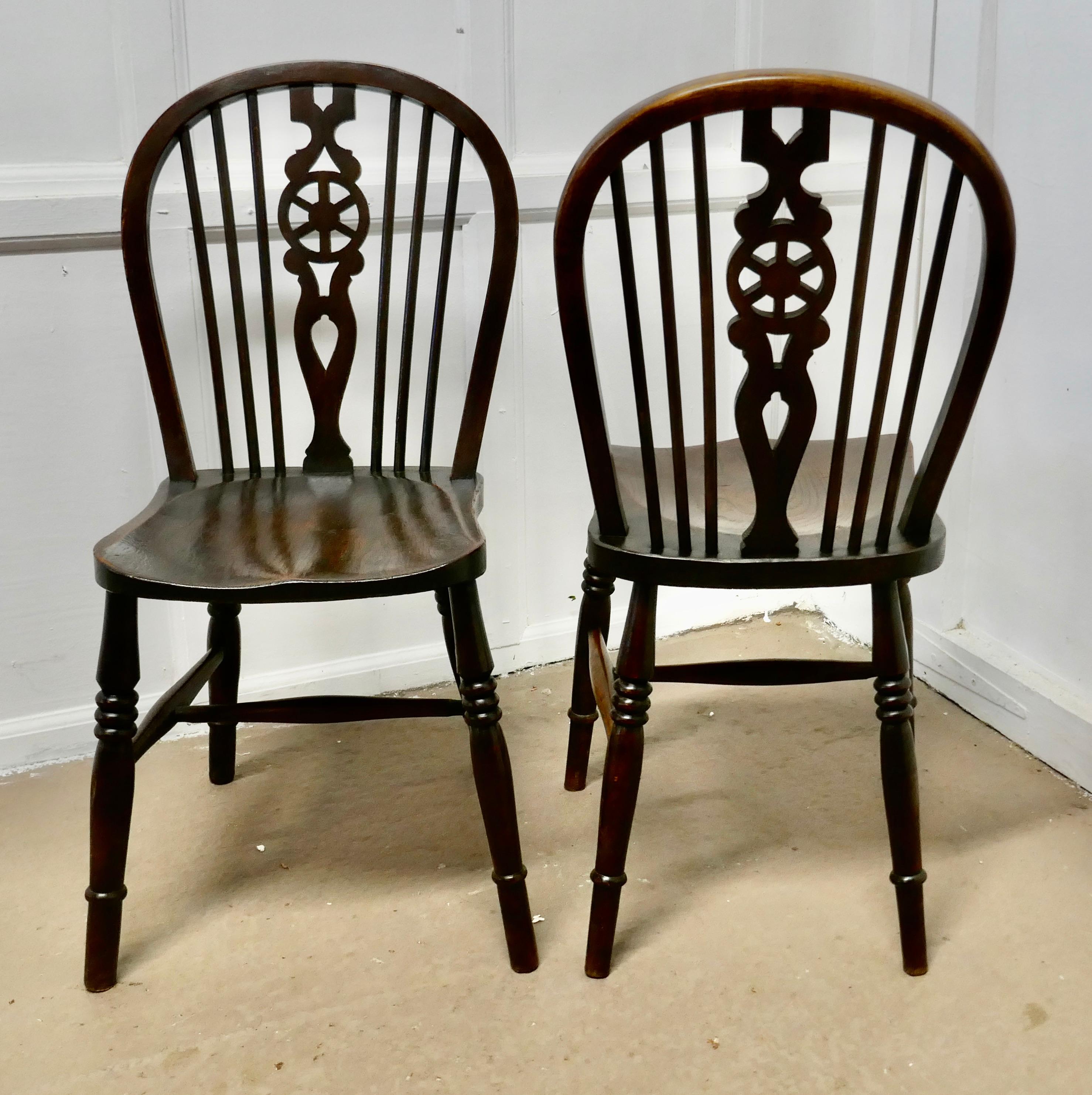 A pair of Victorian beech and elm wheel back chairs


The chairs are a Classic design and traditionally made from solid wood they have hooped backs in the traditional Windsor style with spindles and a pierced centre splat in the shape of a wagon