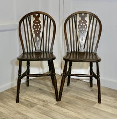A pair of Victorian Beech & Elm Wheel Back Wedge Chairs