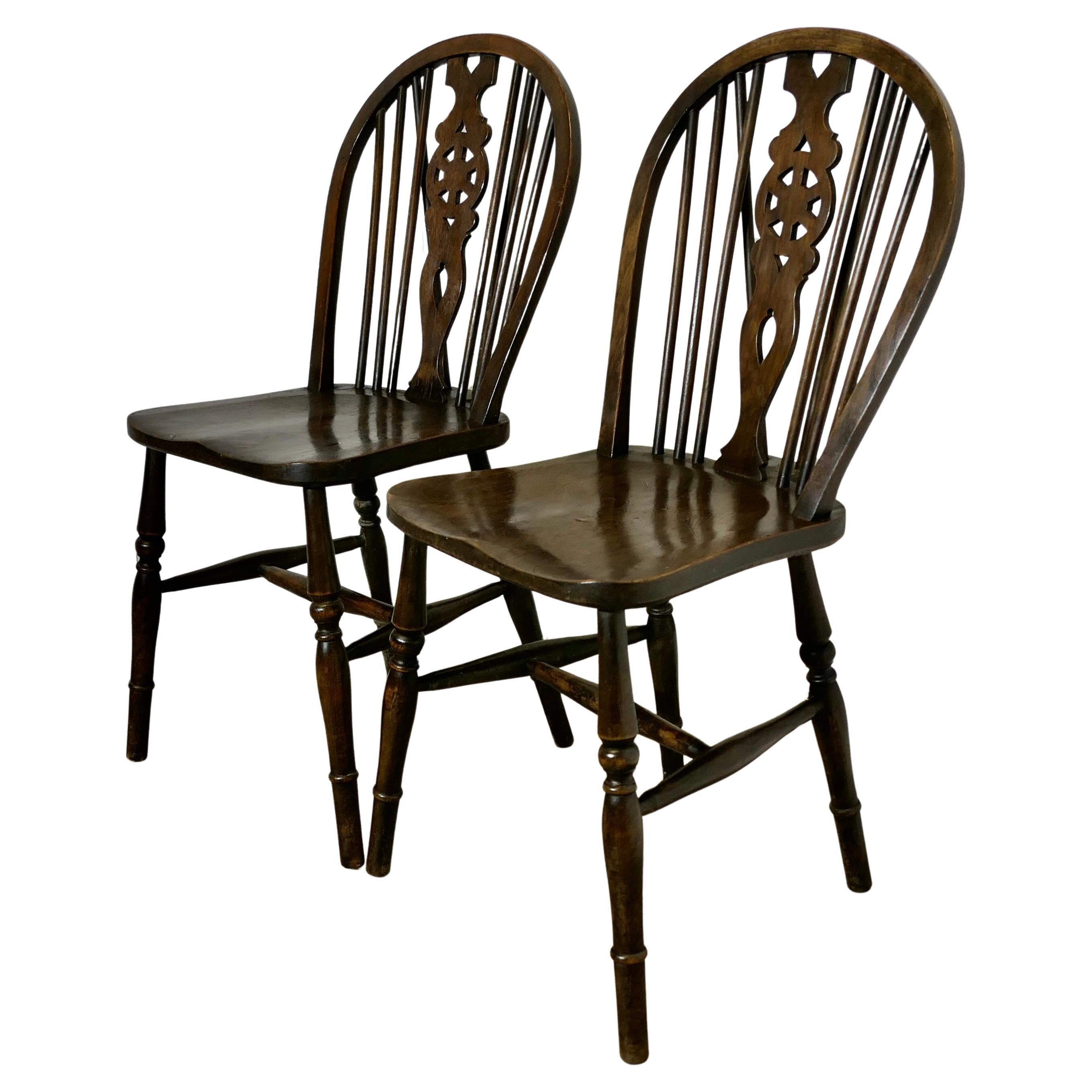 A pair of Victorian Beech & Elm Wheel Back Wedge Chairs