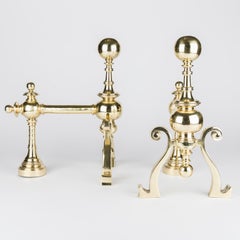 A pair of Victorian brass fire dogs