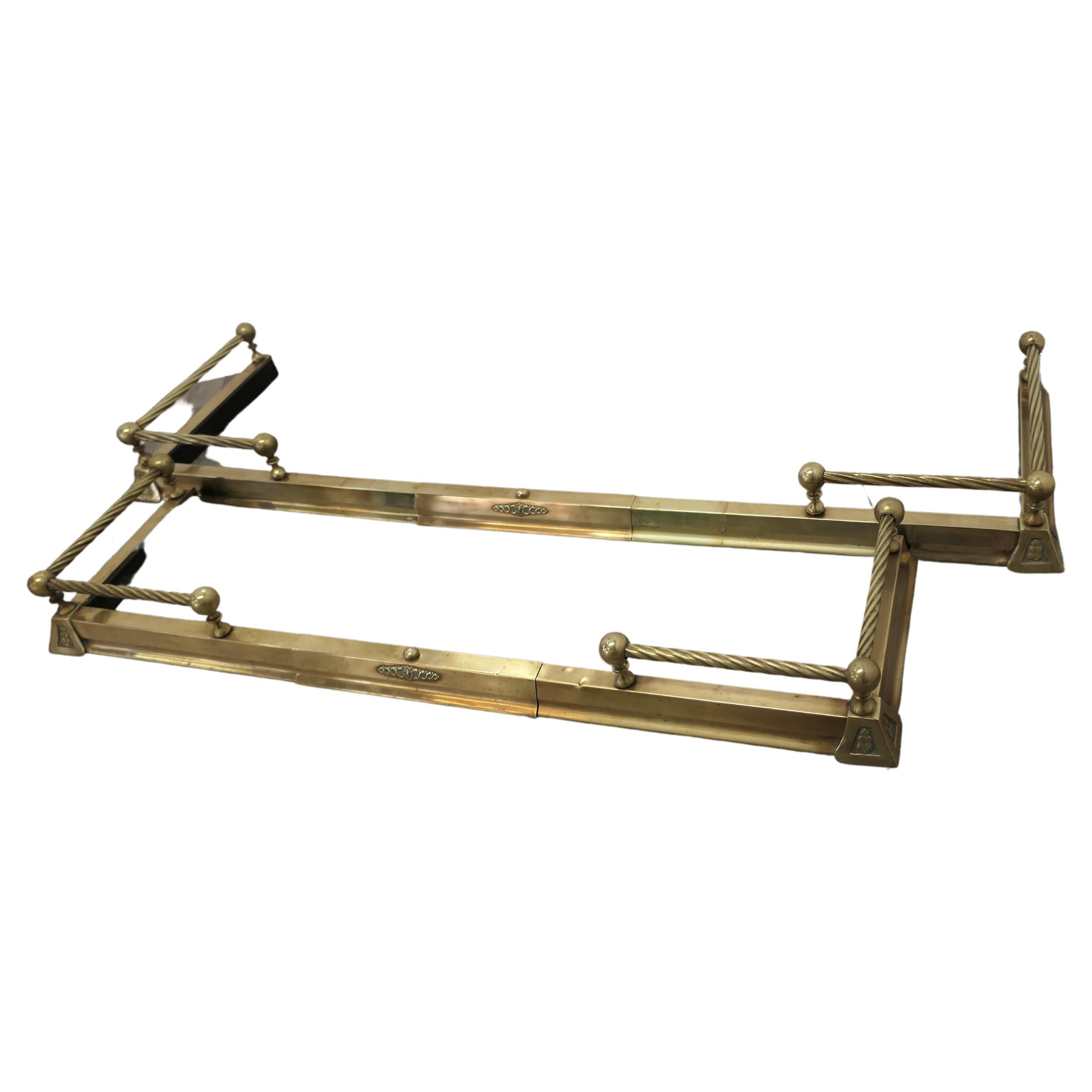 A Pair of Victorian Extending Barley twist brass fenders

This is a very attractive Pair of Brass Fenders they have a brass base with a barley twist brass rail above and small decoration to the corners of the base

The Fenders are both in good