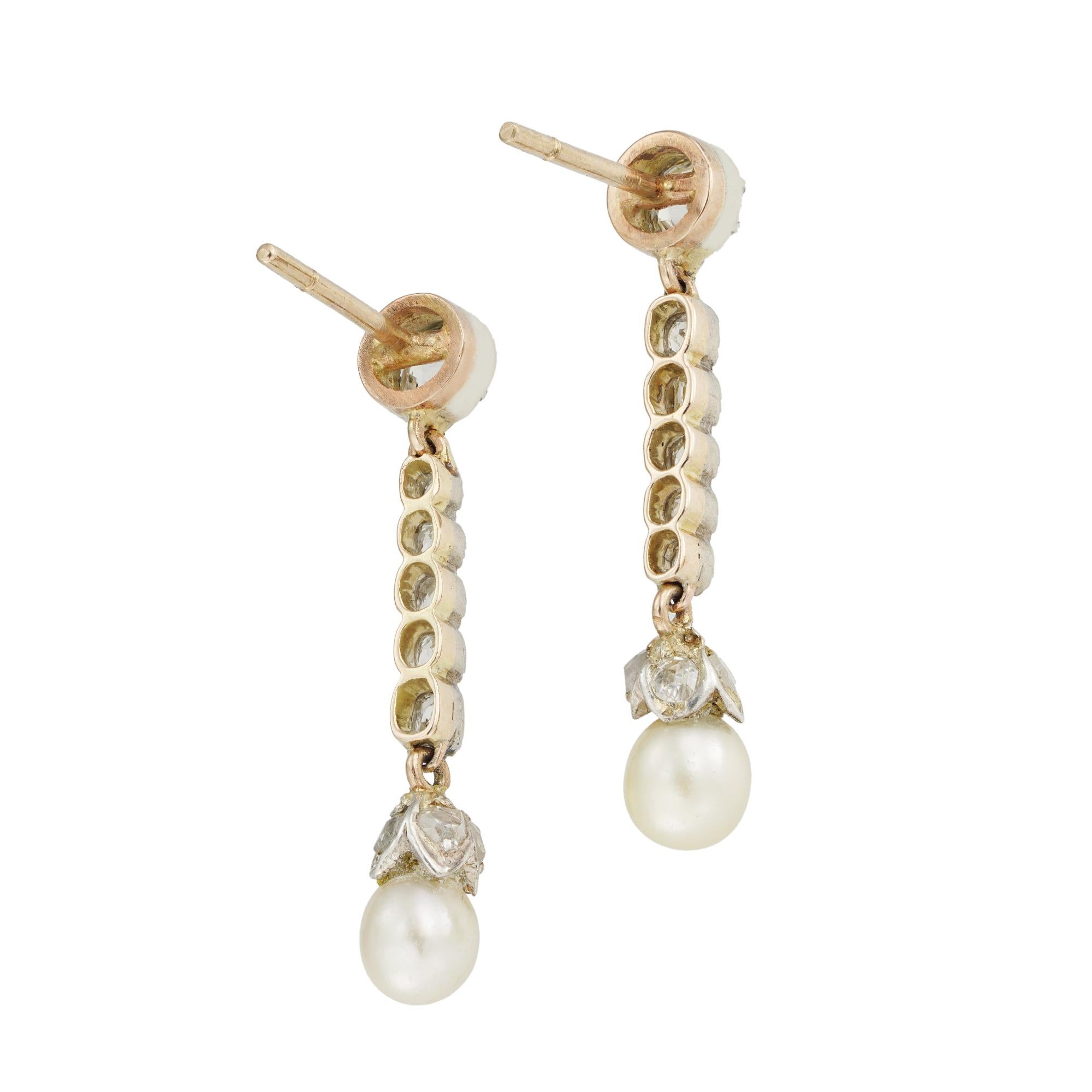 A pair of Victorian natural pearl and diamond drop earrings, each earring with an old-cut diamond top estimated to weigh 1/3 carat, suspending a row of five small old-cut diamonds, terminating to a pearl-set drop with a rose-cut diamond-set cup, the