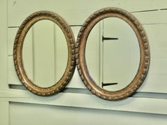A pair of Victorian Simulated Wood Finish Oval Mirrors