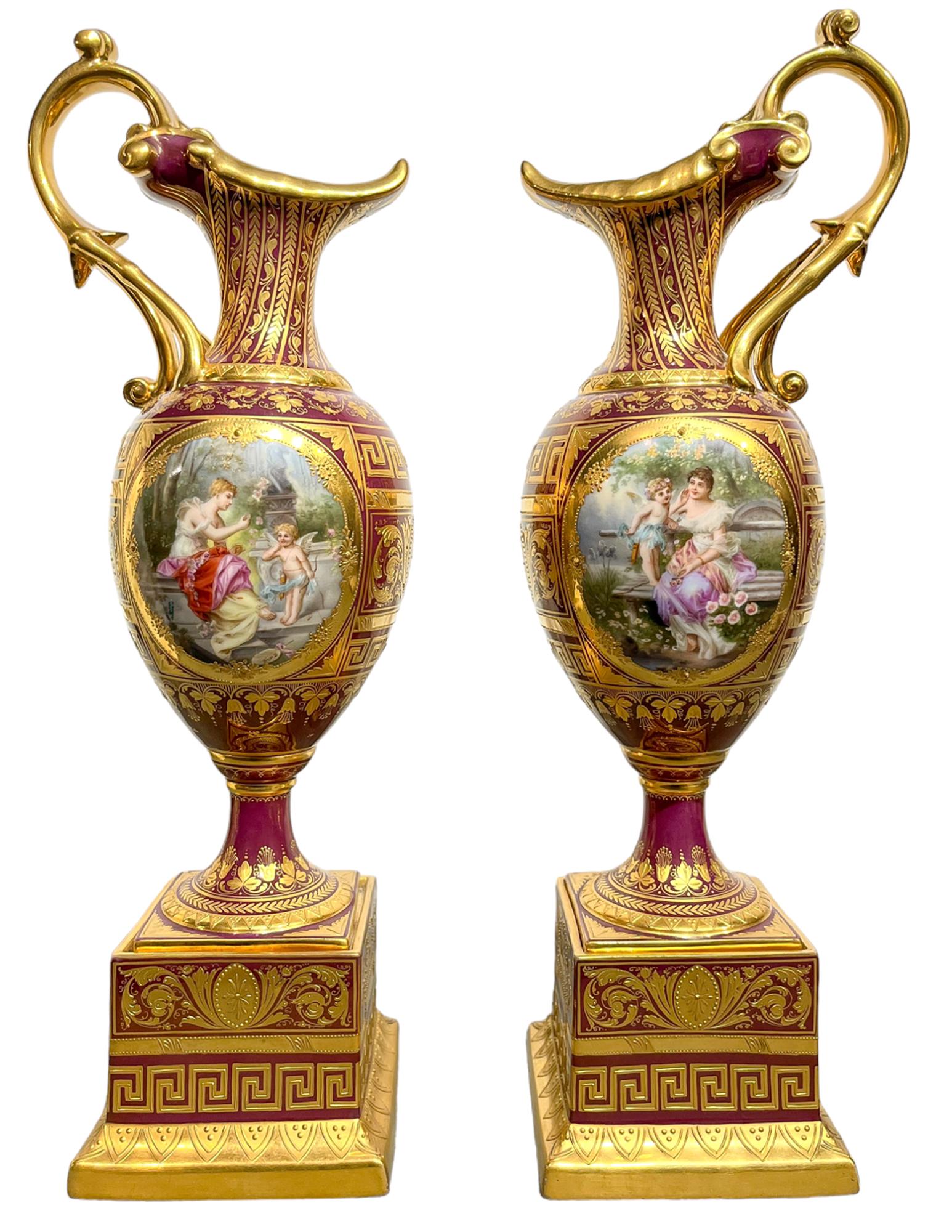 A Pair of Vienna Style Porcelain Iridescent Burgundy Ground Ewers on Stands 

Discover Stunning Late 19th/20th Century Austrian Porcelain Ewers: A Masterpiece by Wagner! These Vienna Style iridescent burgundy ewers, adorned with Pre-Raphaelite