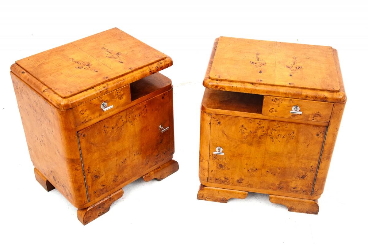 A pair of mid-20th century vintage bedside tables.

The tables have one drawer and a spacious cabinet, silver metal handles. Color: light brown, yellow, gold. Very good condition, after professional renovation. We recommend.

Origin – Poland,

Wood