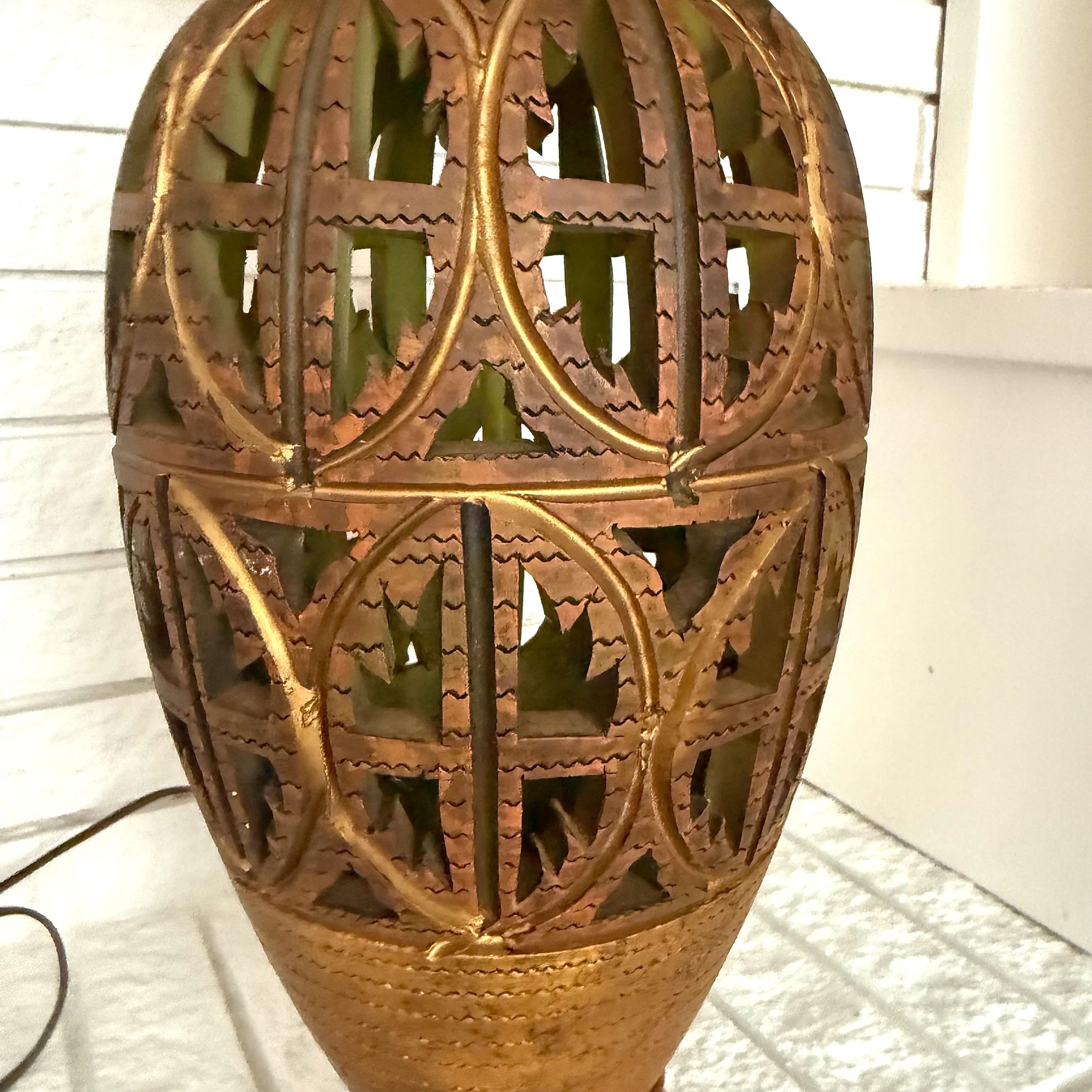Vintage Boho Punch Cut Palm Frond Ceramic Table Lamps - a Pair

A fabulous pair of vintage palm beach regency  table lamps. A punch cut palm frond design with a matte glazed gold finish.   The inside of the lamps are a stunning shade of green.  