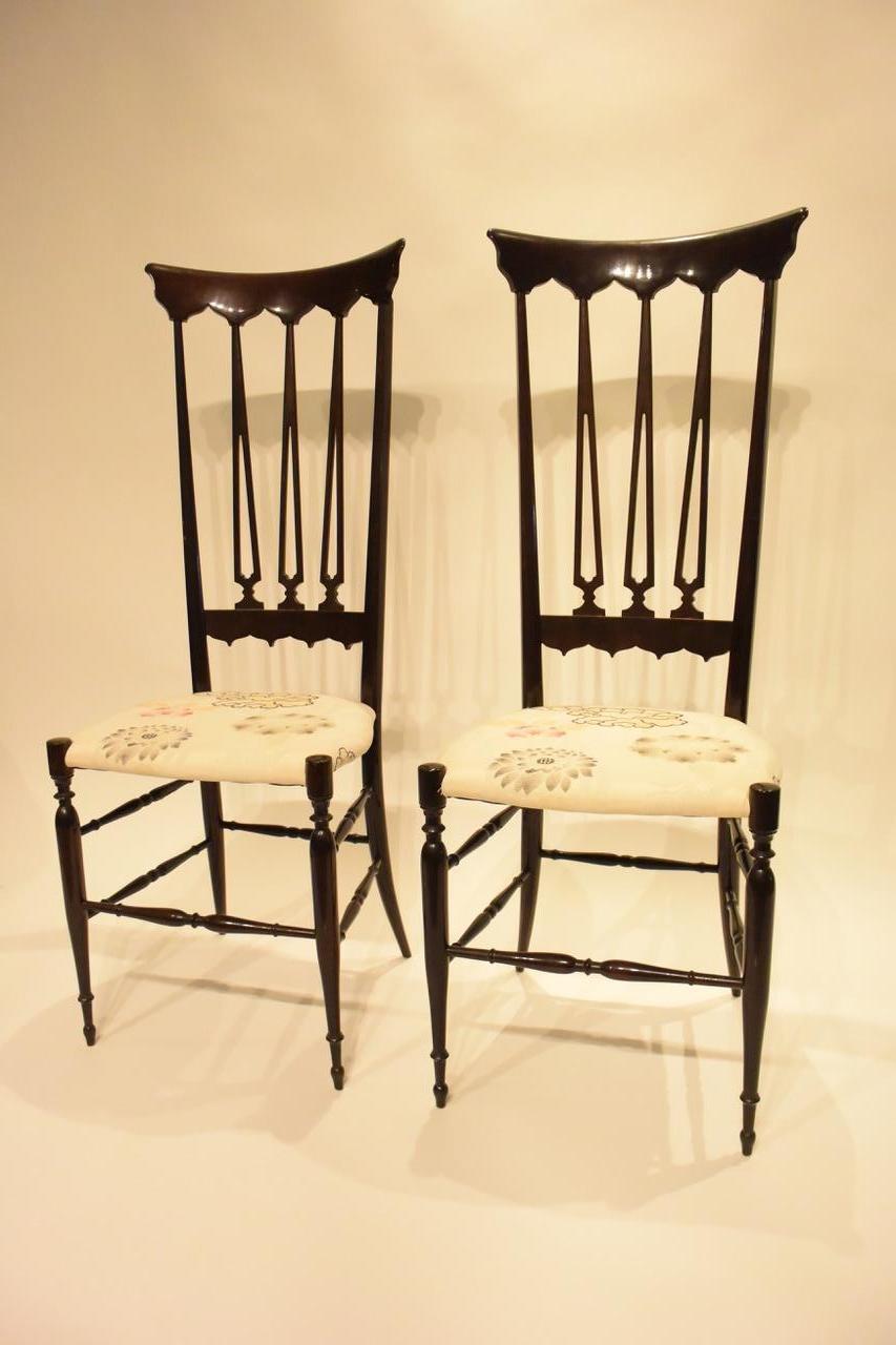 A pair of vintage high back Chiavari chairs in restored condition with seats upholstered in Bergamo floral fabric. This elegant model called Spada is no longer produced,
Italy,
1950s.