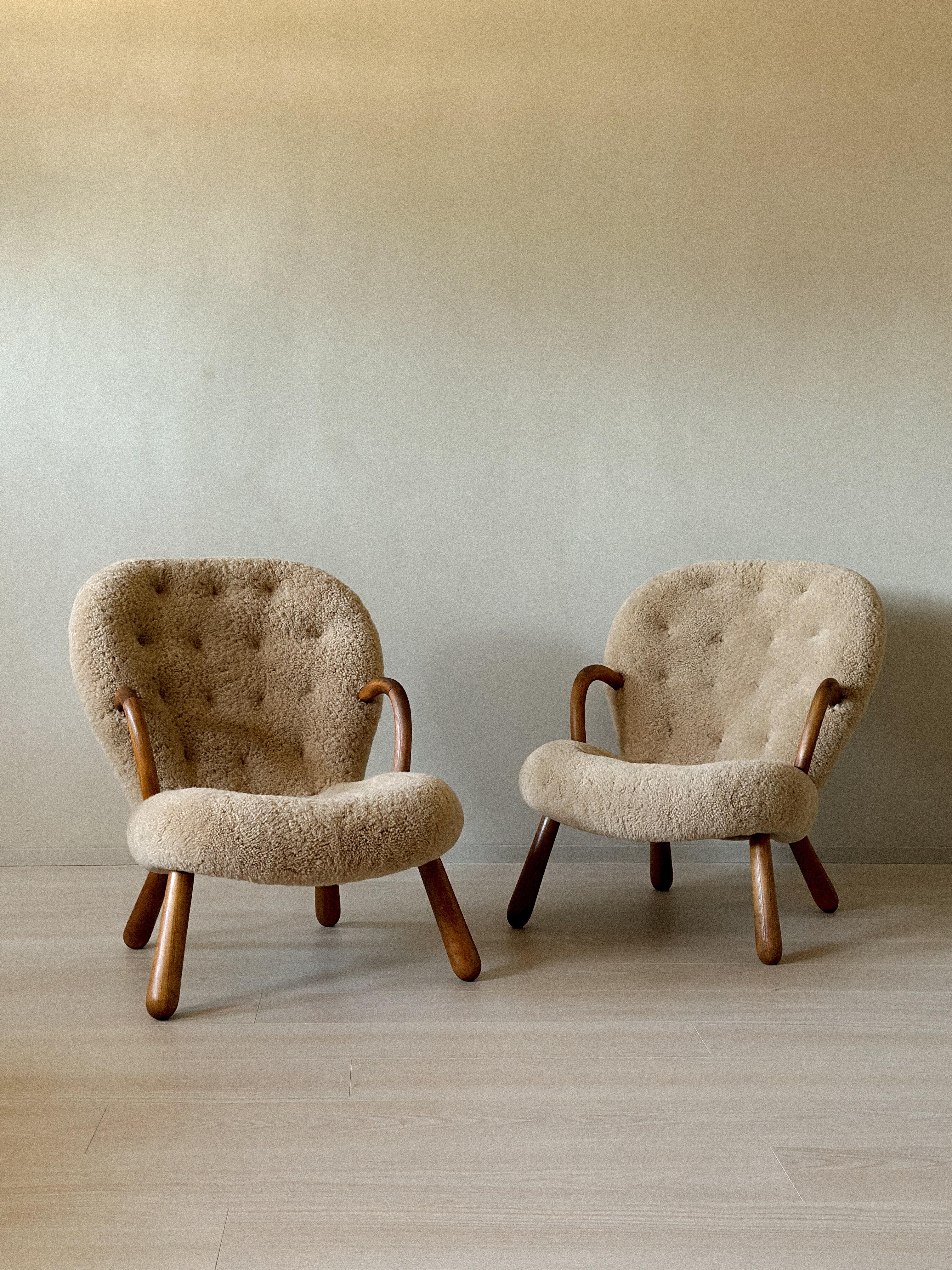 A vintage and authentic pair of 'Clam Chairs' by Arnold Madsen produced by Vik & Blindheim in Norway, 1953. Newly renovated and reupholstered in premium shearling. 

History: 
The iconic Clam Chair traces its origins back to 1944, when Danish