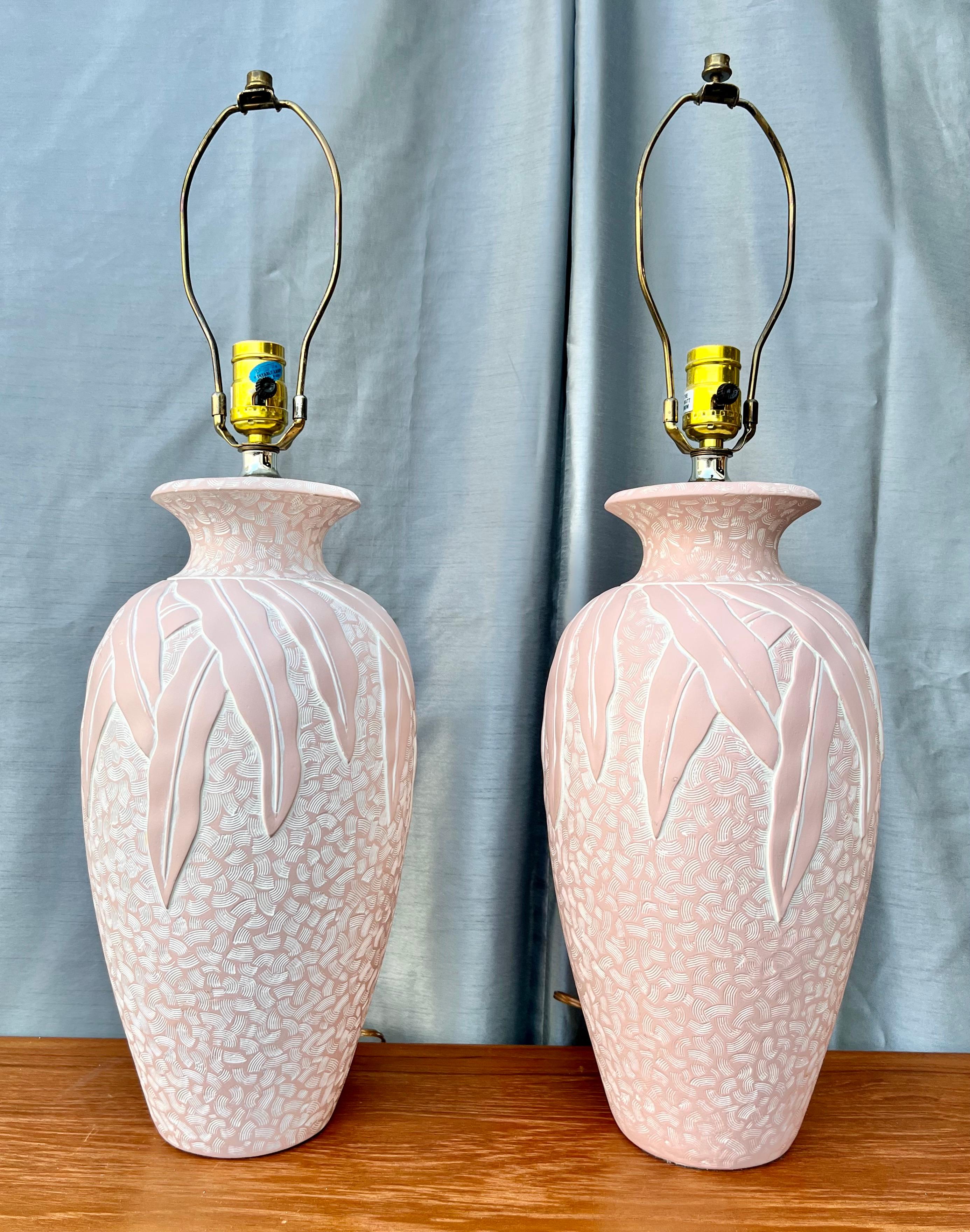 A pair of Vintage Coastal Style Embossed Plaster Table Lamps. Circa 1980s
Feature a sculptural urn-shaped textured plaster body with tropical foliage embossed reliefs
In Excellent Near Mint Original Condition With Very Minor Signs of Wear and