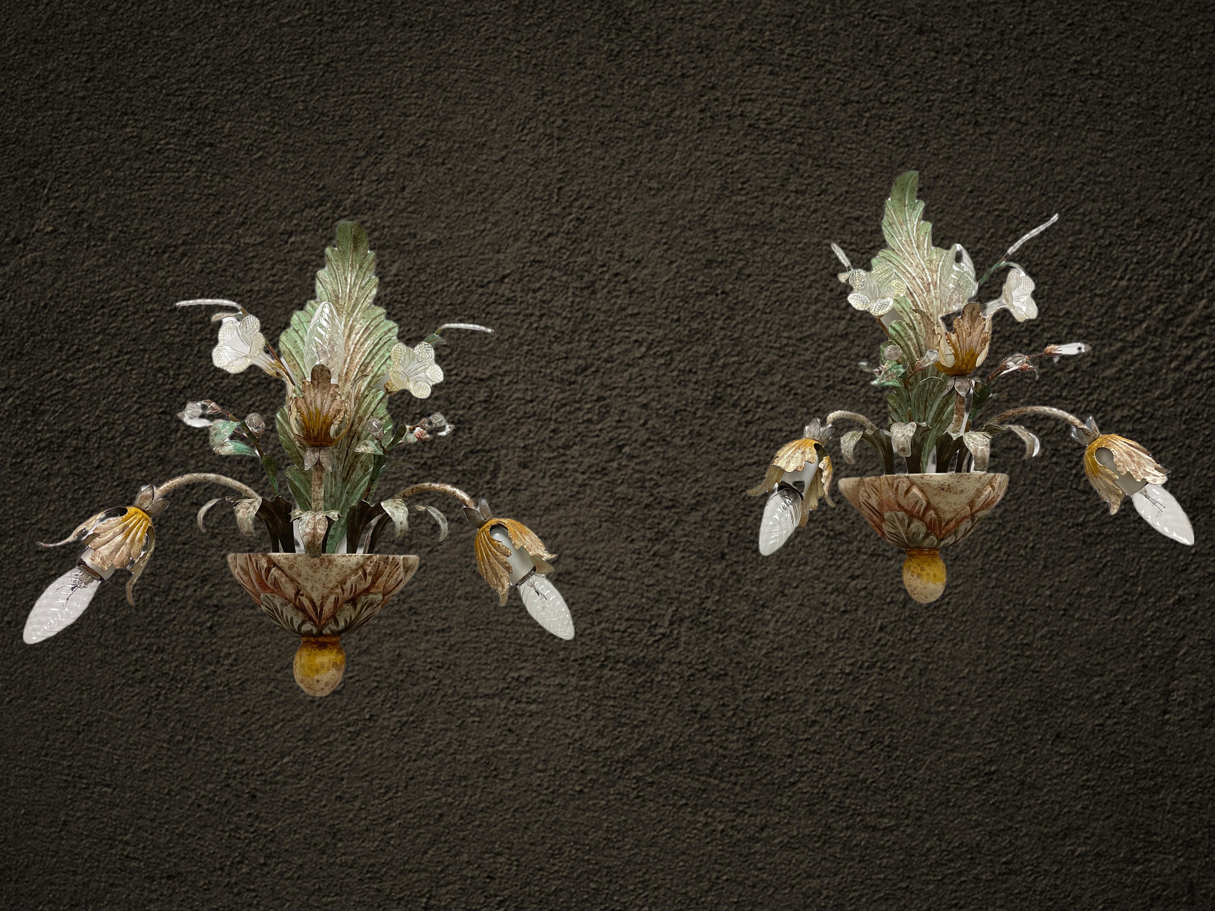 Add a touch of opulence to your home with this charming pair of sconces. Perfect stunning acanthus leaf design with clear and gold flake Murano glass flowers and crystal Murano glass leaves on fine stems, to enhance any chic or eclectic home. We'd