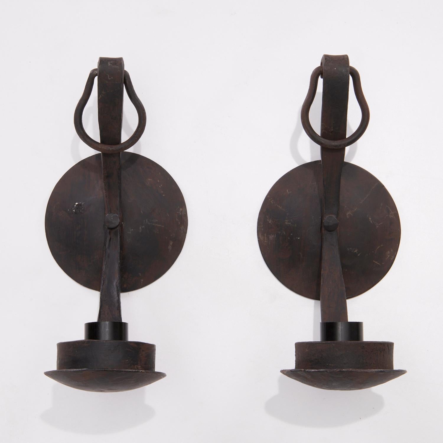 A pair of vintage French 20th c. wrought iron wall sconces in the Art Moderne style, each with a single candle bulb socket. Wired for electricity, unmarked.

These wall sconces are very versatile in terms of design style. Farmhouse Modern,