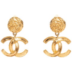 A Pair of Vintage Gold-Toned Chanel '95 Logo Dangle Clip-On Earrings