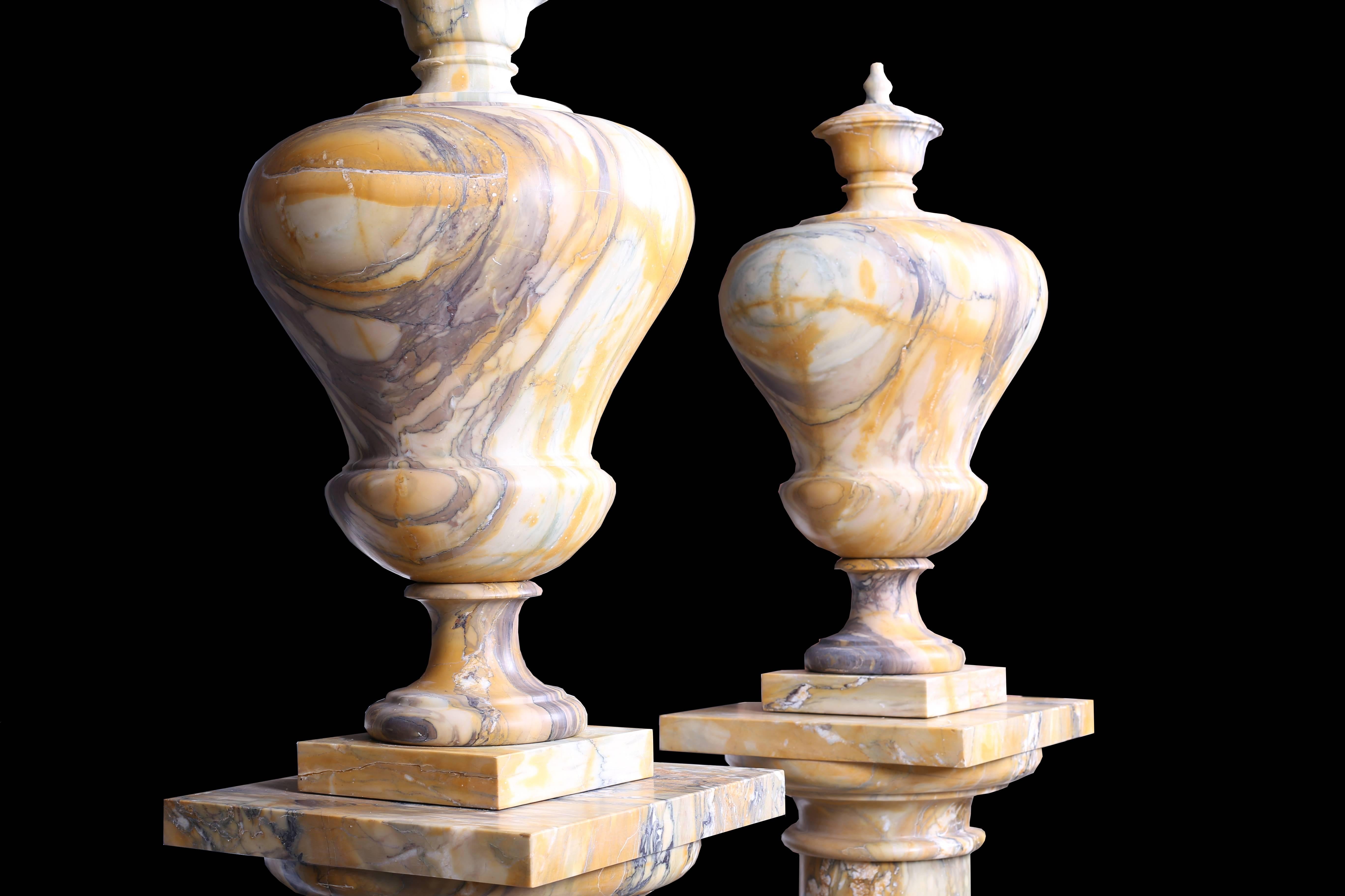 A pair of rather grand vintage and extremely tall early 20th century in high quality Sienna marble urns in the neoclassical style, raised on high quality Sienna marble column plinths with Sienna marble bases, Italian, circa