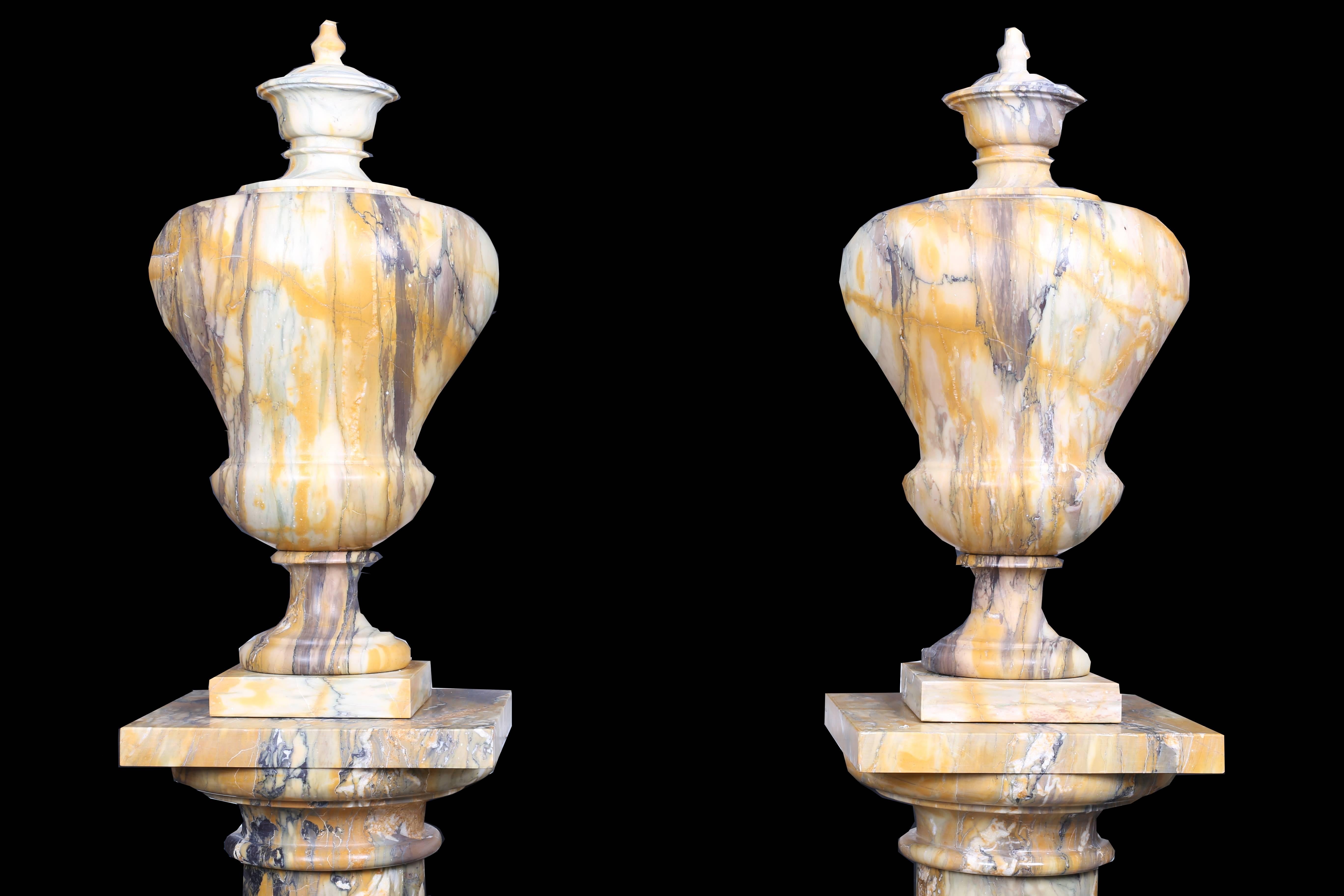 Neoclassical Revival Pair of Vintage Grand Marble Urns on Column Plinths in the Neoclassical Style For Sale