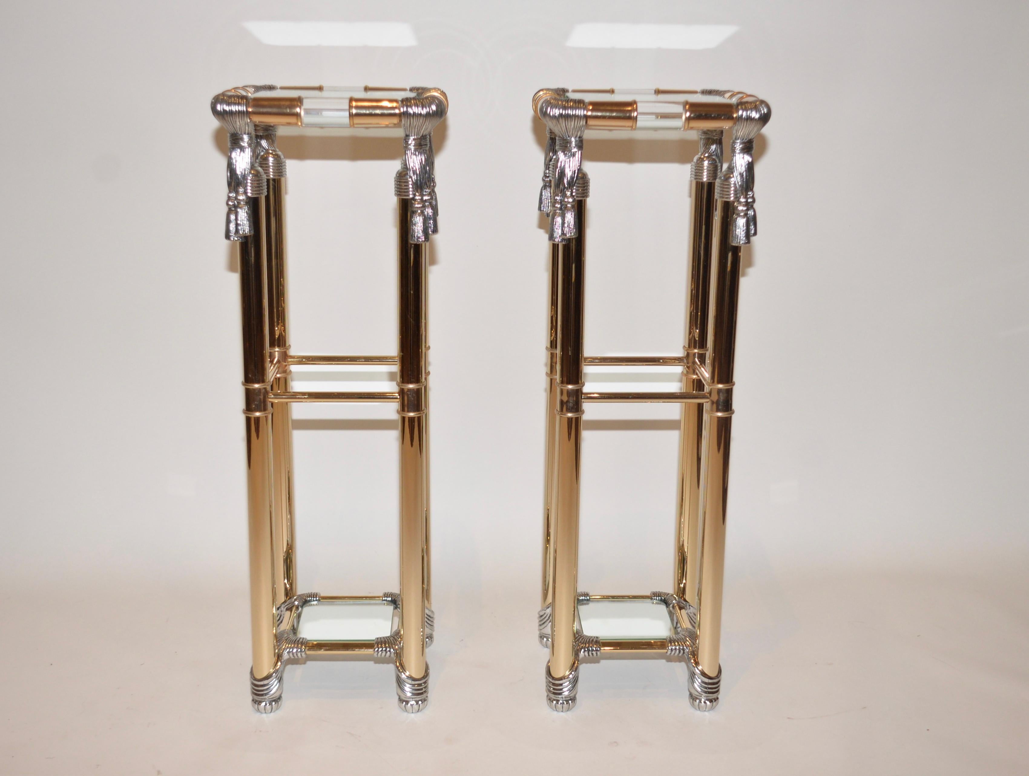 A pair of vintage Curvasa Meubles Hollywood Regency style pedestal stands. Lucite and gold with silver rope detailing on each corner. Very striking items which have the designers attribution label stamped on them.
  