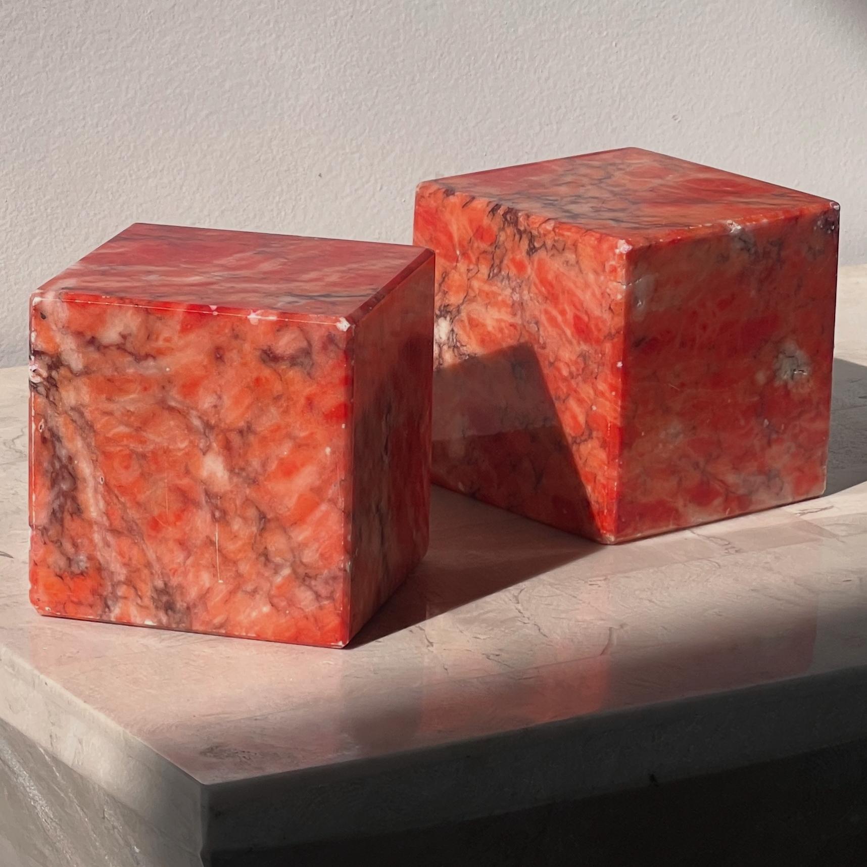 A pair of vintage Italian alabaster bookends, mid 20th century. In rare scintillating tones of coral and persimmon with aubergine veining, these unique bookends will add bold style and sophistication to any interior. Hand carved with extraordinary