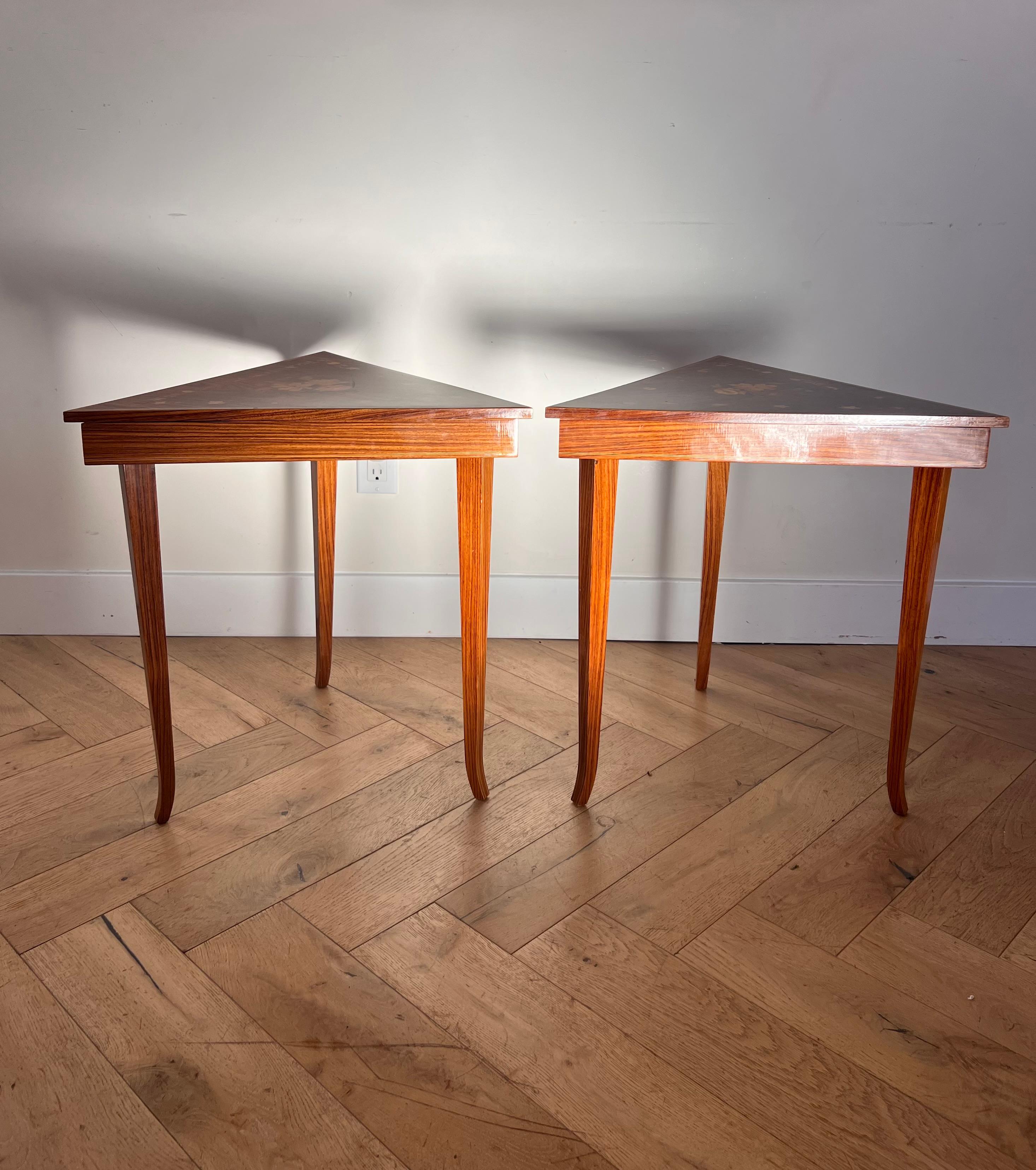 A pair of vintage Italian marquetry side tables of triangular shape, made in Sorrento circa 1960. Featuring inlaid floral motif. When the top is open, o
ne table plays “Love Story”, the other plays “Come Back to Sorrento.” Able to be sold