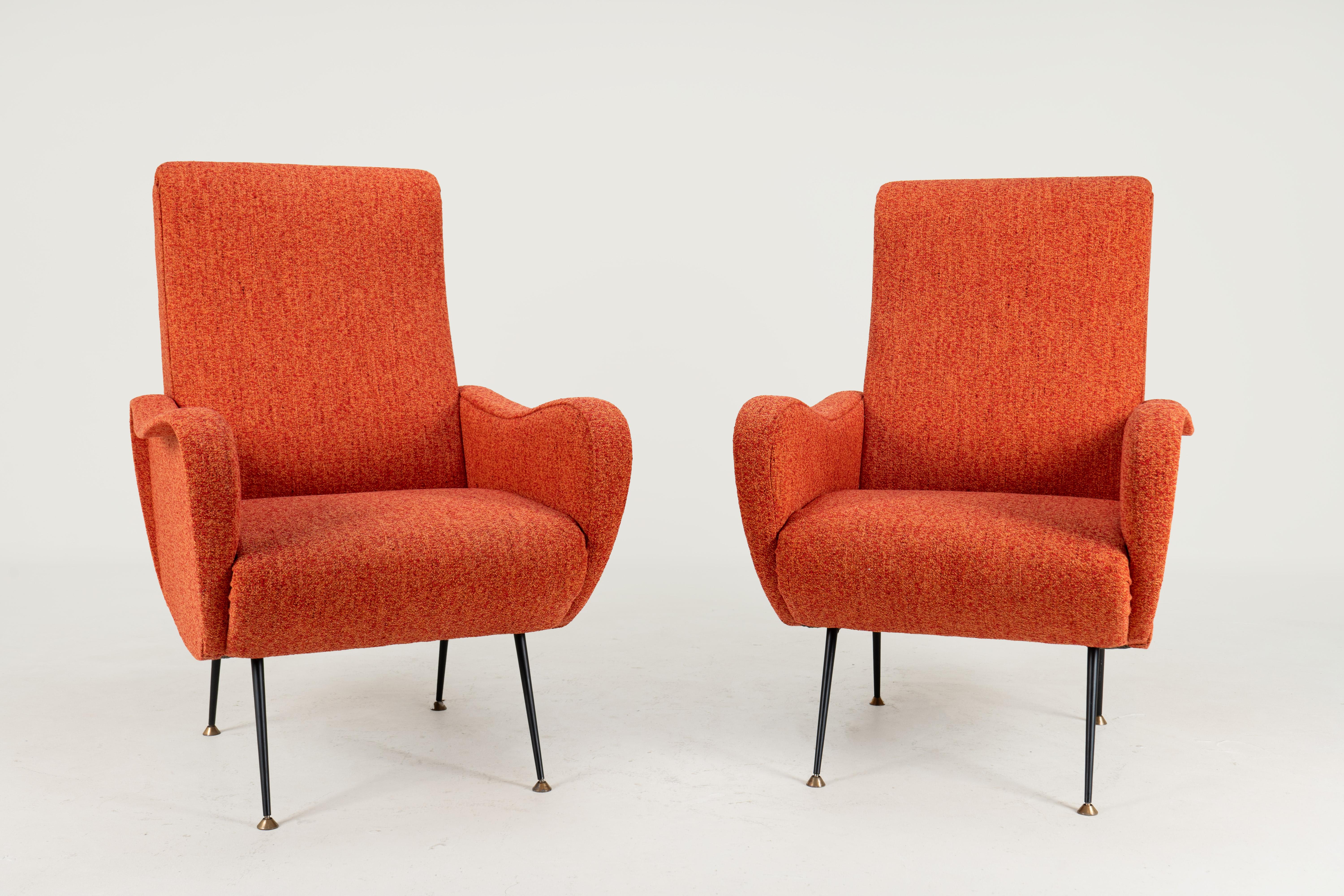 A classic pair of Italian Mid-Century lounge chairs in the style of Marco Zanuso's 'Lady Chairs'. The chairs are set upon boldly sprayed and tapered solid brass legs. The overall form is sensuous and organic, and chairs are a visual treat, as well