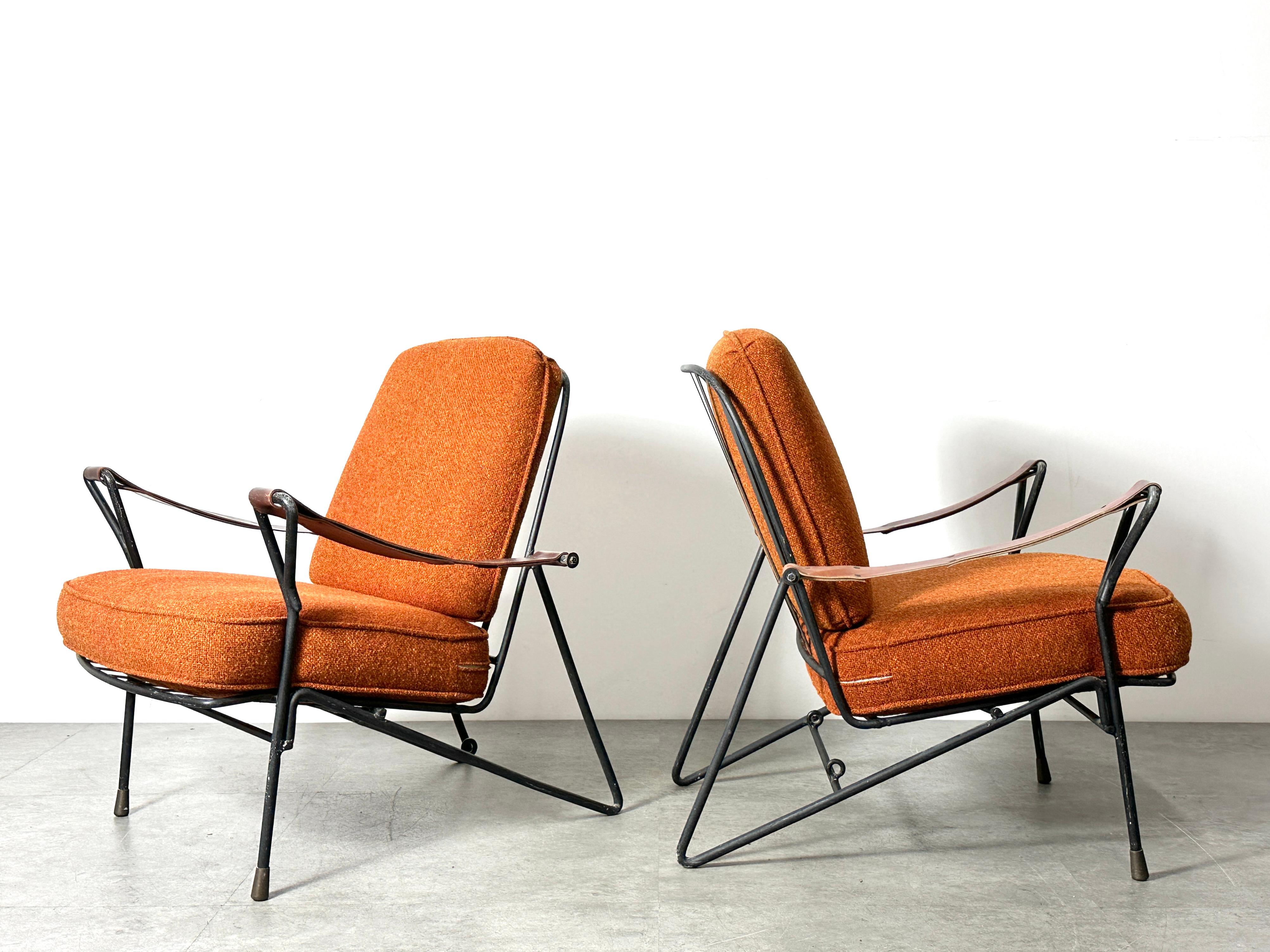 A pair of modernist Mexican lounge chairs circa 1950s
Enameled iron frames / leather strap sling armrests / brass capped feet
Loose cushions in a rust orange