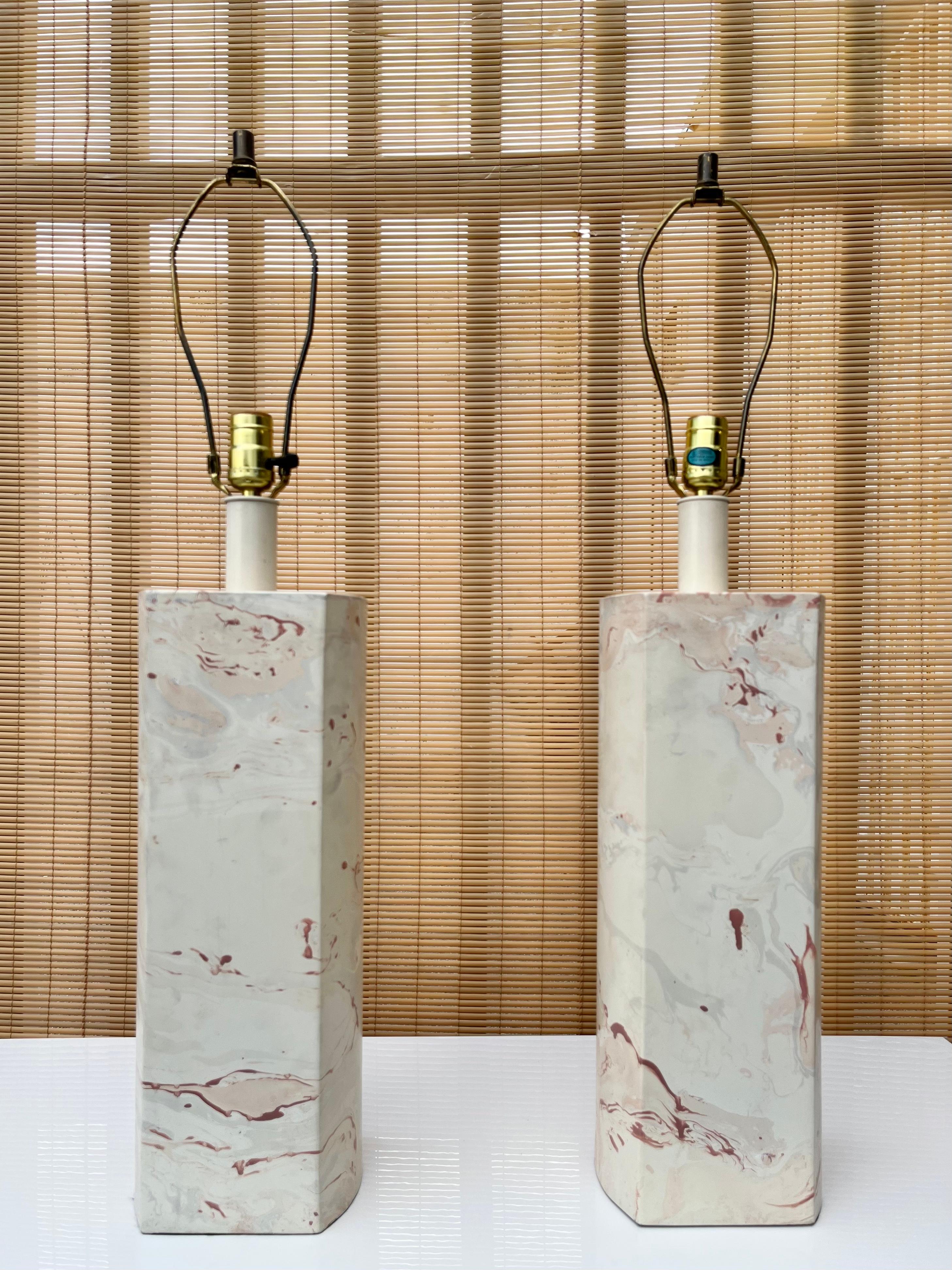 A pair of Large Size Postmodern Faux Marble Table Lamps. Circa 1980s.
Feature a man made material bases with rounded sides and pink and cream marbleized laminated finish. 
In excellent original condition with minor signs of wear and age. Please