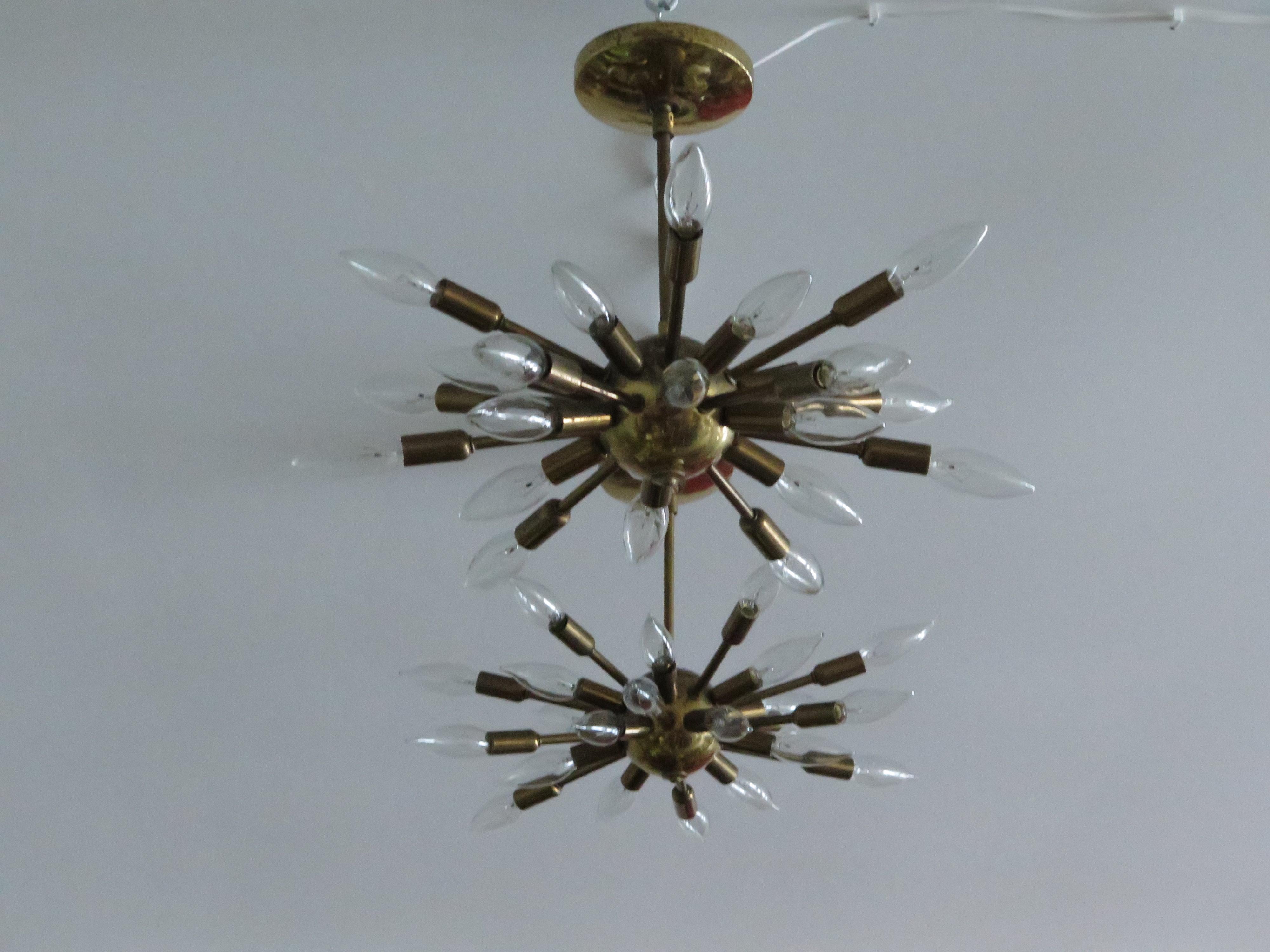 A pair of small scale-vintage Sputnik chandeliers. Made of brass-and heavy unlike the contemporary copies. Each chandelier has 24 arms-measuring 14.5
