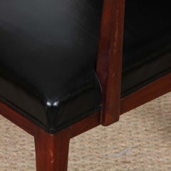A pair of vintage wooden and leather armchairs from the 1950s