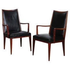 A pair of vintage wooden and leather armchairs from the 1950s