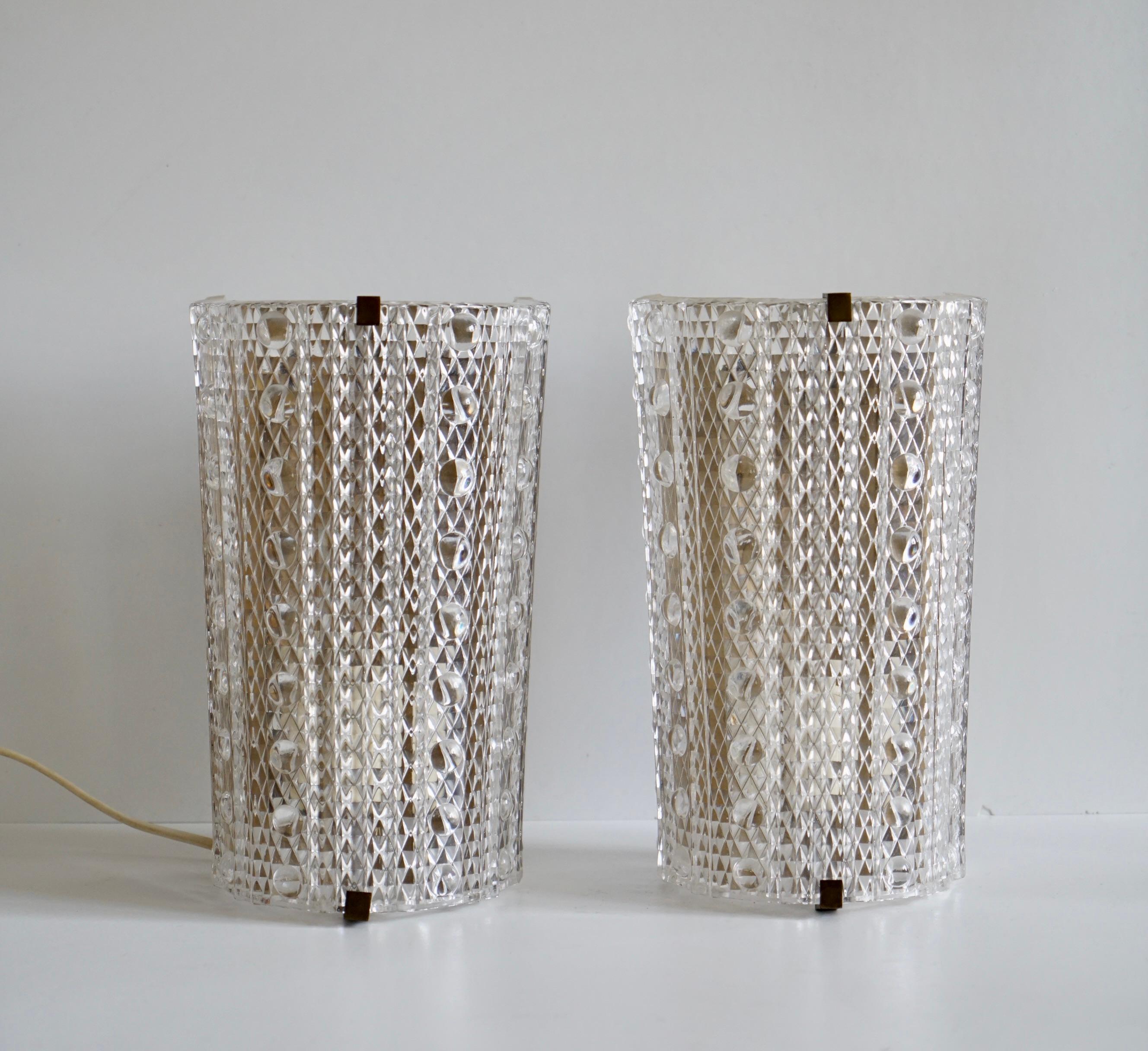 A pair of wall lights designed by Carl Fagerlund for Orrefors , Sweden. Circa 1950th. Produced by LYFA. 
Marked by Manufacturer . Clear pressured glass on brass hardware. Single candelabra socket. The fixture must be rewire prior
