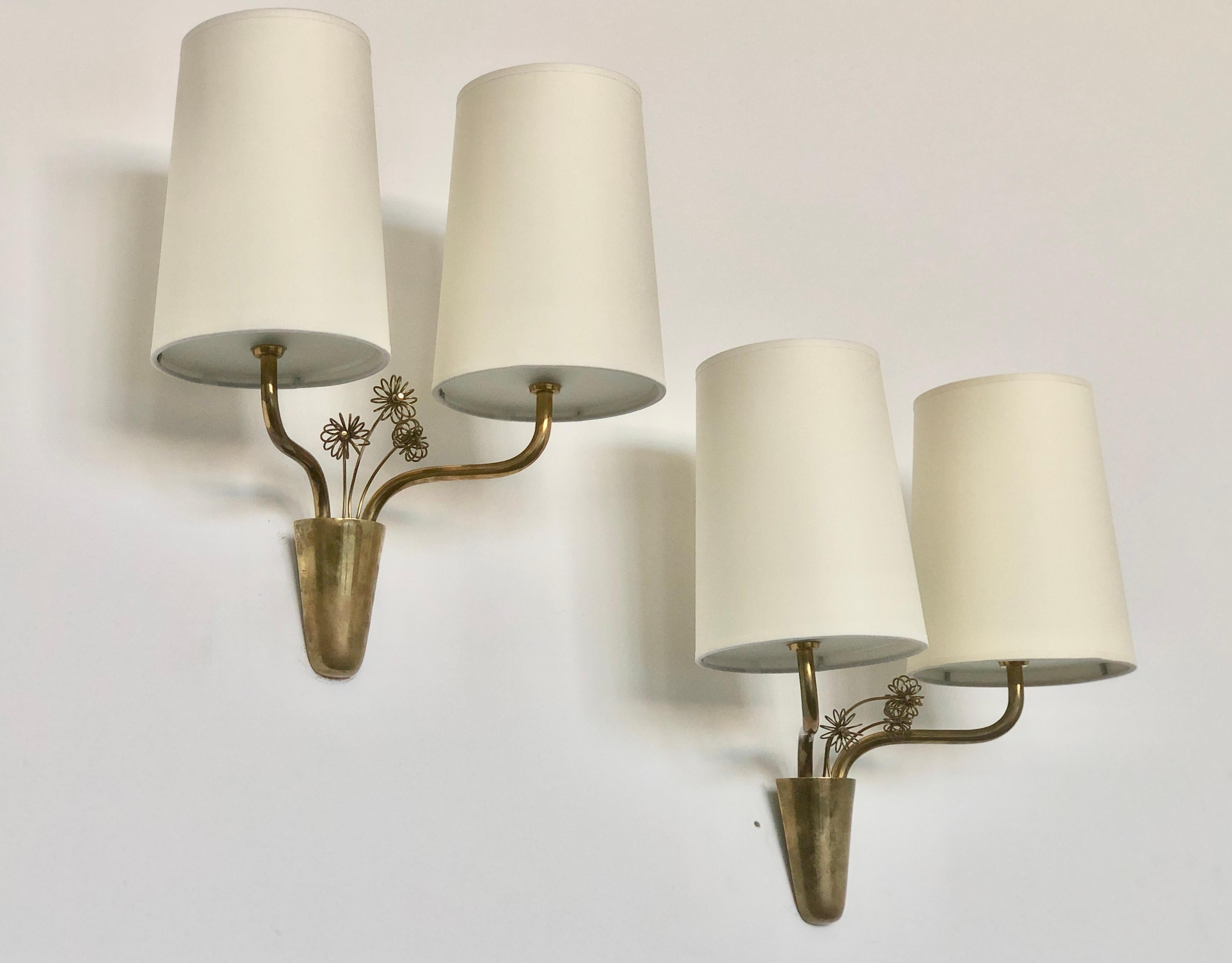 A pair of wall lights designed by Paavo Tynell for Idman, Finland , Circa 1950th.
Model Number 9445,  featured at Idman catalogue.
Brass, frosted glass and paper shades.
Rewiring available upon request.