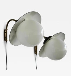 A pair of wall lights by Paavo Tynell for Taito Oy.
