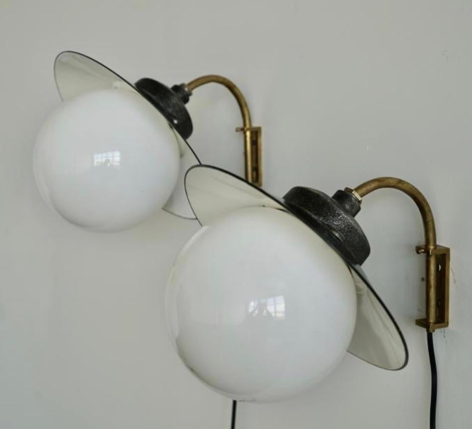 Scandinavian Modern A pair of wall lights by Paavo Tynell for Taito Oy. For Sale