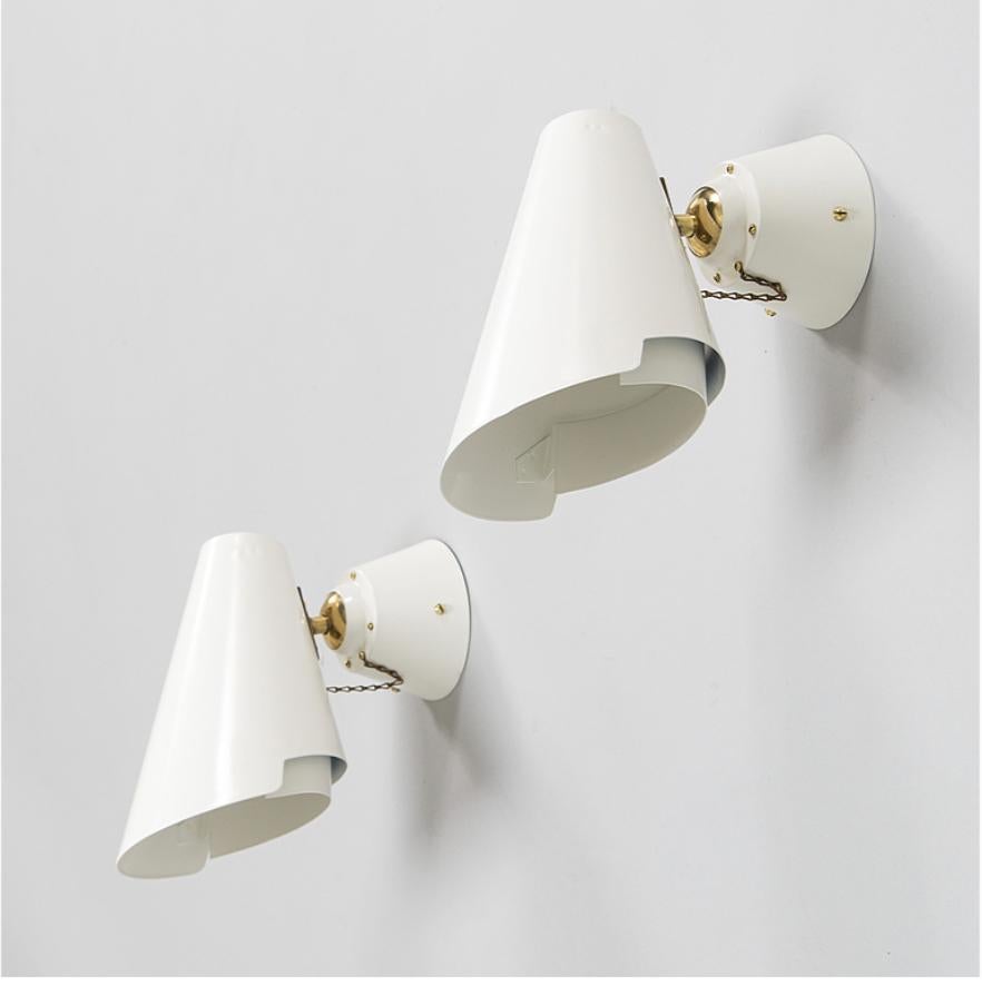A pair of wall lights designed by Paavo Tynell , for Taito/ Idman. Model number '2351' . Finland , circa 1950th.
Con-shaped lampshades. Adjustable direction. 
Renovated and repainted. Rewiring available upon request.