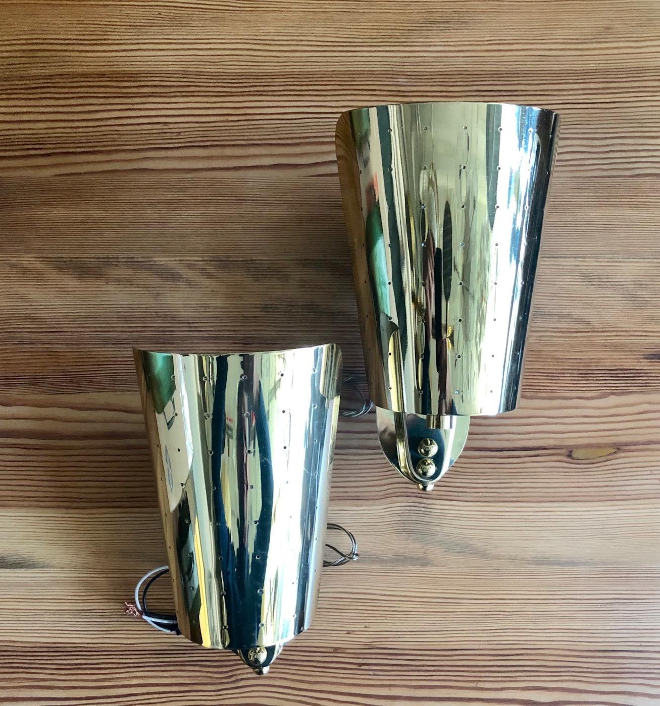 Midcentury pair of wall lights in style of Paavo Tynell, Finland, circa 1950s.
Perforated polished brass, newly rewired.