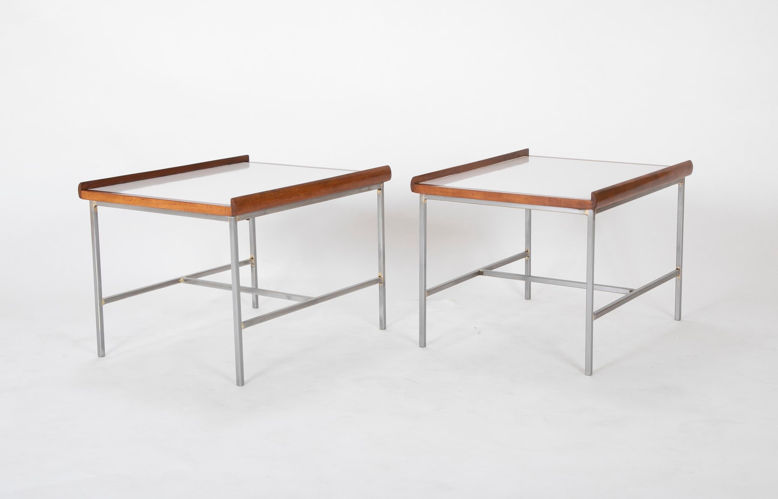 A pair of Paul McCobb style side tables. Walnut with white laminate and steel bases.