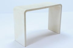 A pair of waterfall console tables in the manner of Jean-Michel Frank.